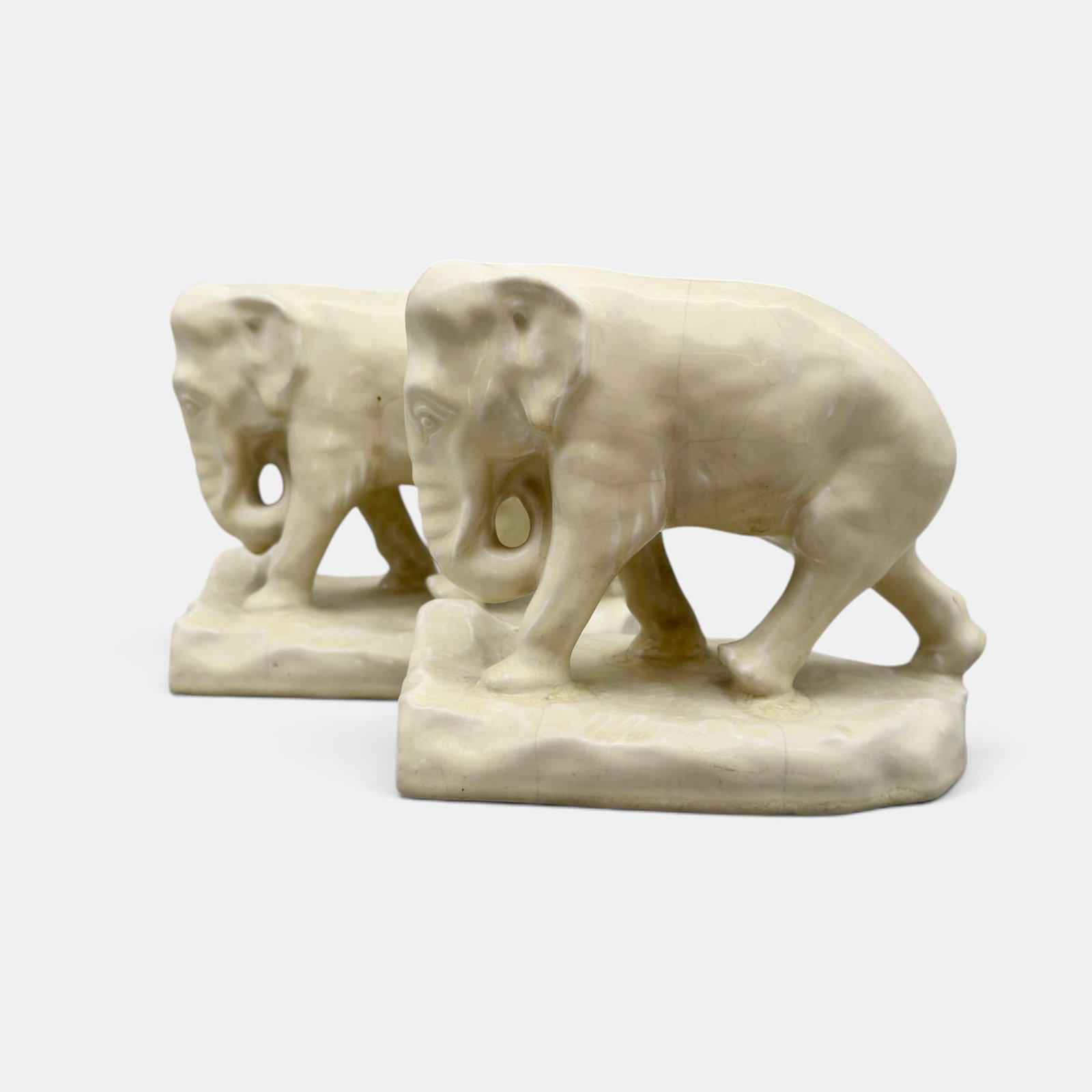 Pair of Rookwood elephant bookends, 1919: Pair of Rookwood Elephant bookends in white mat glaze from 1919. Imoressed Rookwodo logo, XIX, Shape number 2444 C. Wheel ground X. Height 5 3/4 inches.