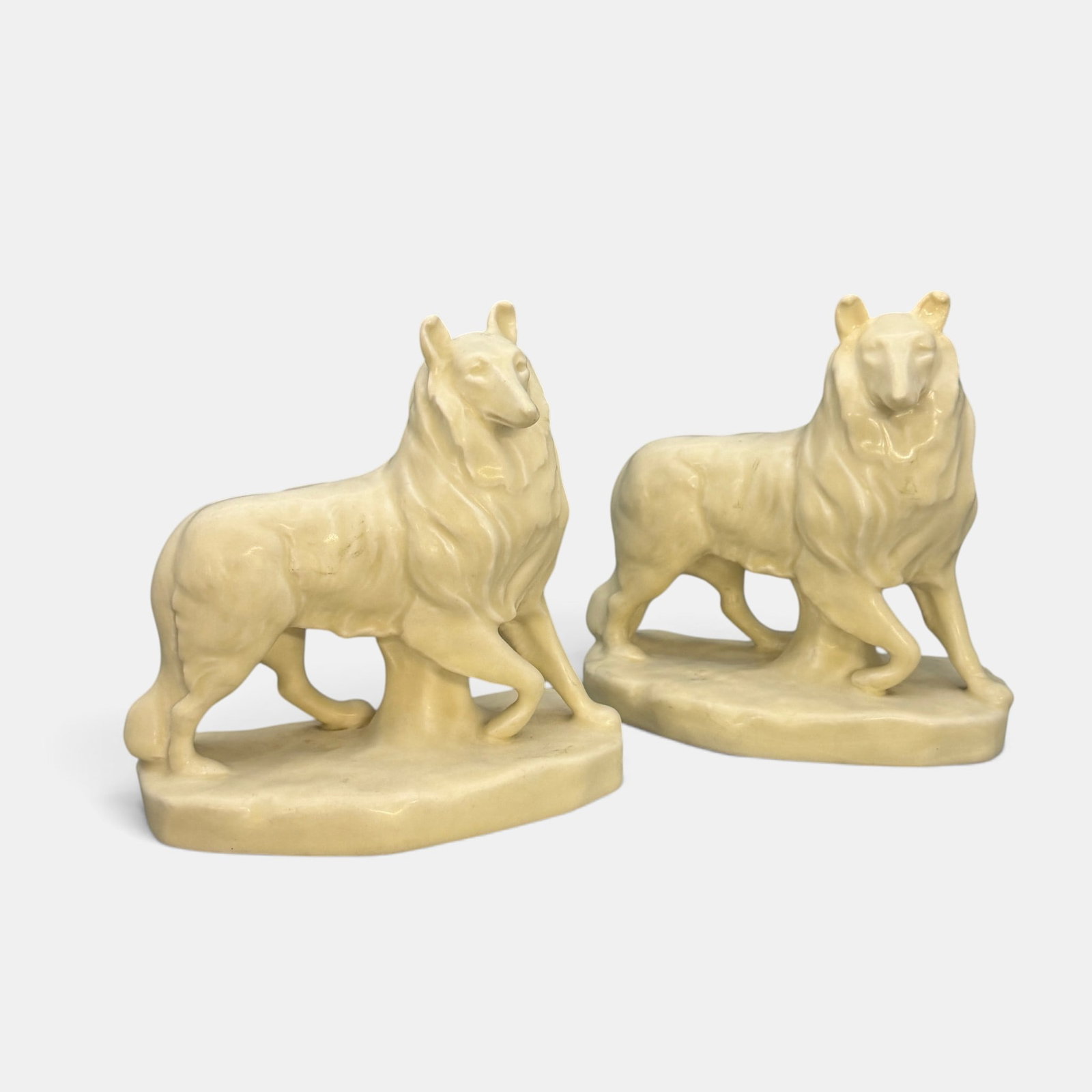 Pair of Rookwood "Collie" bookends, 1928.: Pair of Rookwood "Collie" bookends in white mat glaze, a William McDonald design done in 1928. Impressed Rookwood logo, XXVIII, Shape number 2778. Height of each 6 1/4 inches.