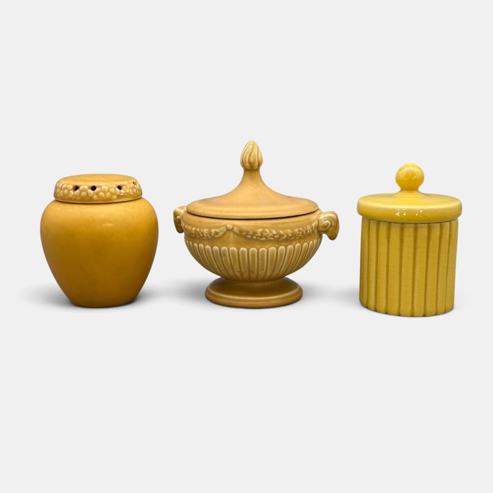 Three yellow Rookwood covered jars with lids.: Three Rookwood covered jars with lids . 1. Mat finish scent jar, 1929, Shape 1321 E. Height 4 inches. 2.Glossy fluted jar, 1948, Shape 6451. Height 4 3/ inches. 3. Mat glaze jar with ram head