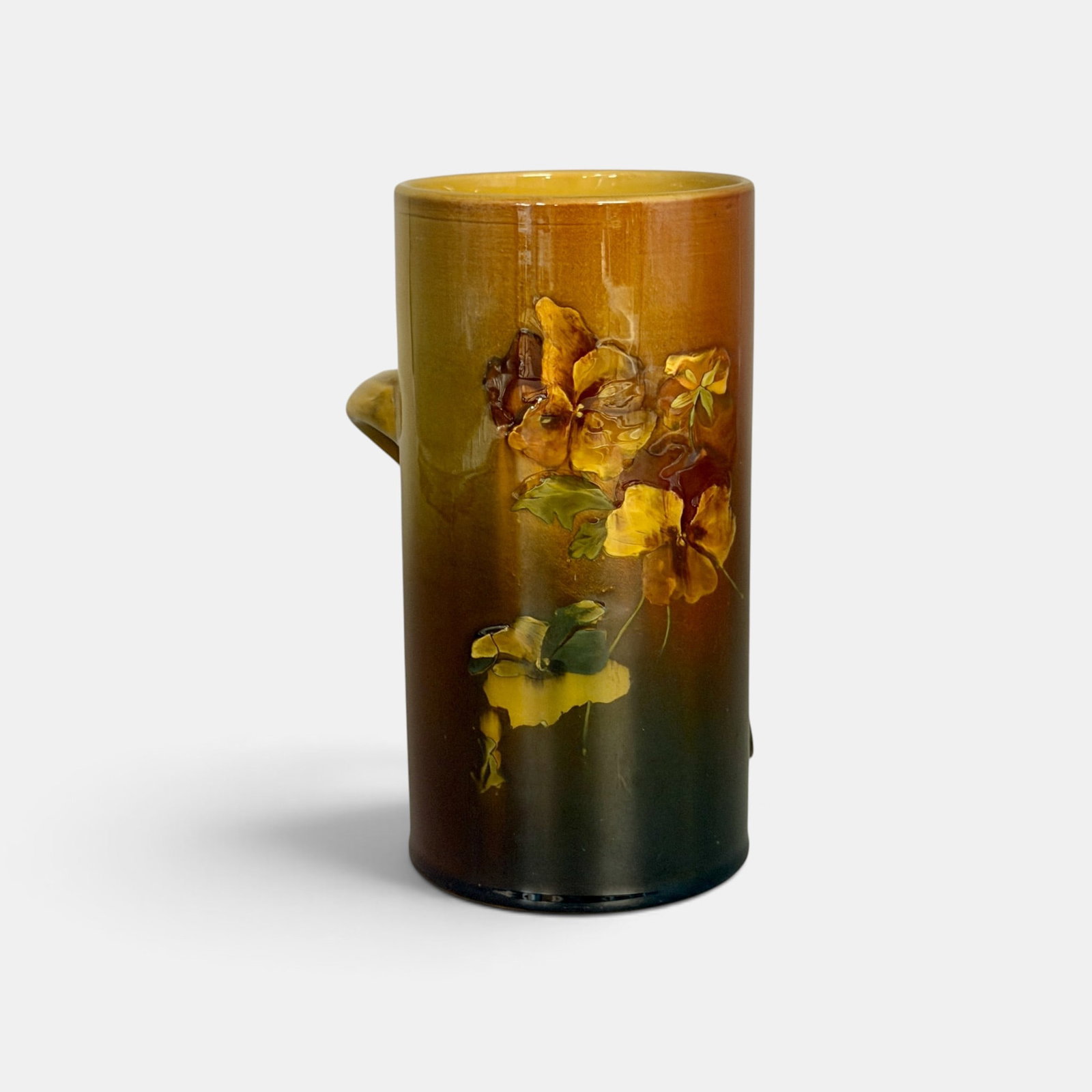 Rookwood Standard glaze mug with pansy decor, Toohey, 1890: Rookwood Standard glaze mug wih offset handle and nicely painted pansies, the work of Sallie Toohey in 1890. Impressed Rookwood logo with four flames, Shape number 328 B, Y for yellow clay. Incised