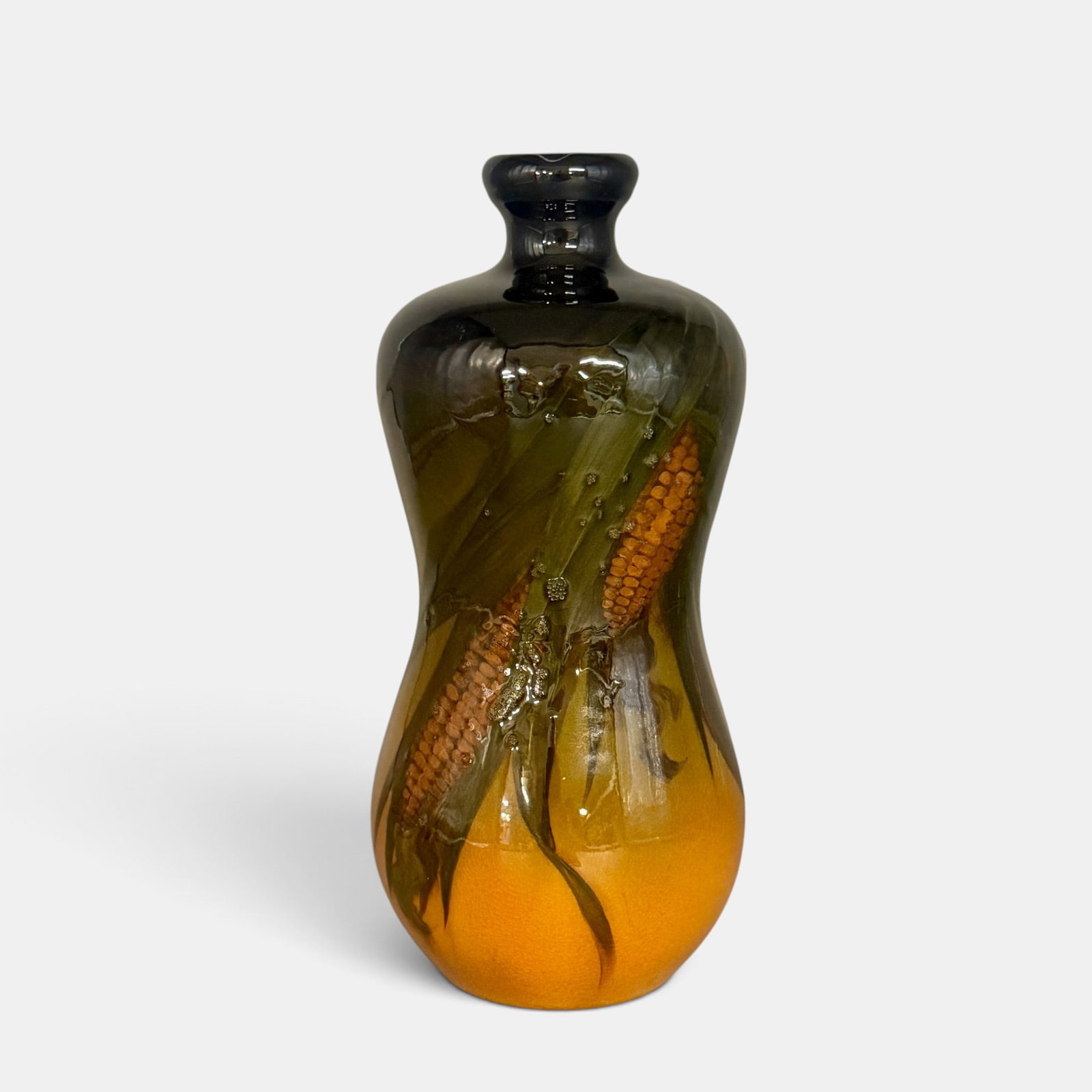 Rookwood Standard glaze whiskey jug, corn, AMV, 1897: Rookwood Standard glaze whiskey jug with ears of corn done by Anna Valentien in 1897. Impressed Rookwood logo with 11 flames, Shape number 677, a triangle shaped esoteric mark. Incised AMV initials.