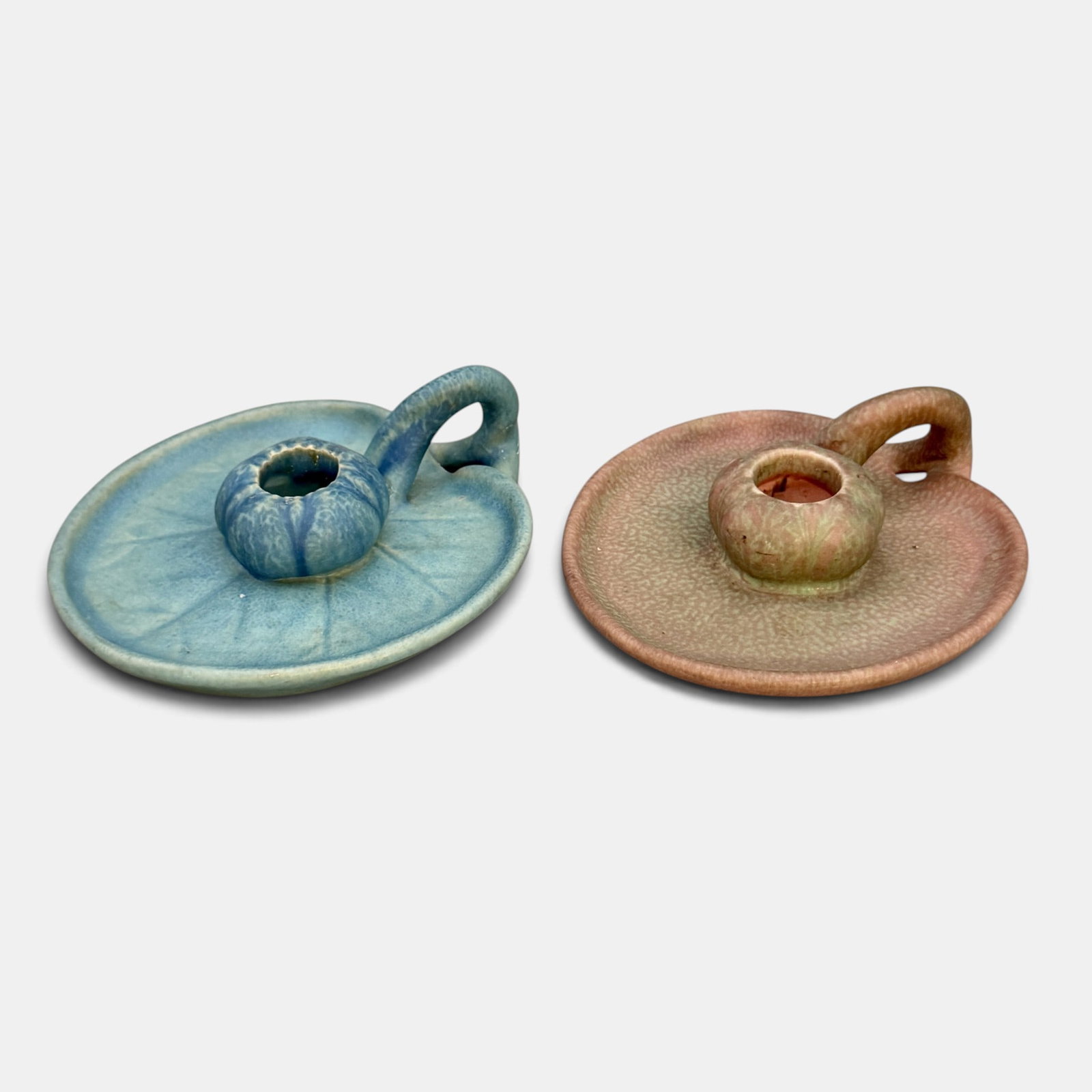 Two Rookwood candleholders, 1916 and 1926: Two Rookwood candleholders, one in blue mat from 1916 and one in a green over rose mat from 1926. Impressed Rookwood logo, XVI and XXVI, Shape number 1067. Height of each is 1 3/4 inches and width is 