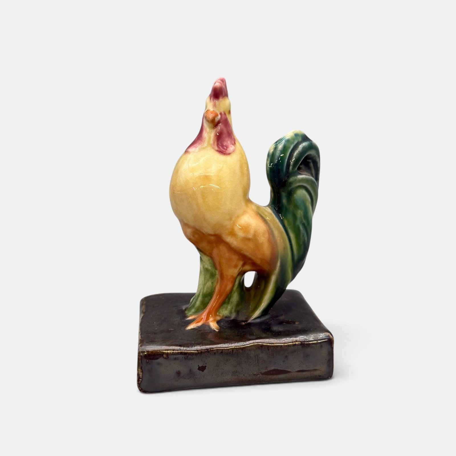 Rookwood Rooster paperweight, 1943: Polychromed Rookwood rooster paperweight with Nubian Black plinth. Impressed Rookwood logo, XLIII and Shape number 6030. Height 5 1/8 inches.,