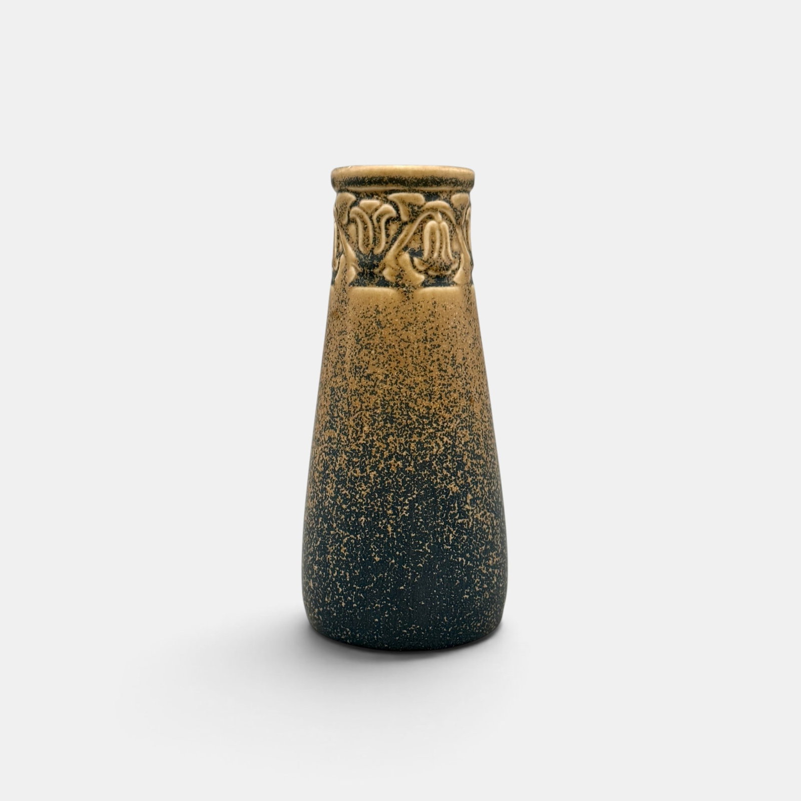 Rookwood production vase, blue over tan glaze, 1924: Rookwood production vase with embossed bell flowers covered in a fan-favorite speckled blue over tan mat glaze. Impressed Rookwood logo, XXIV, Shape number 2111. Cincinnati Art Galeries paper label fo