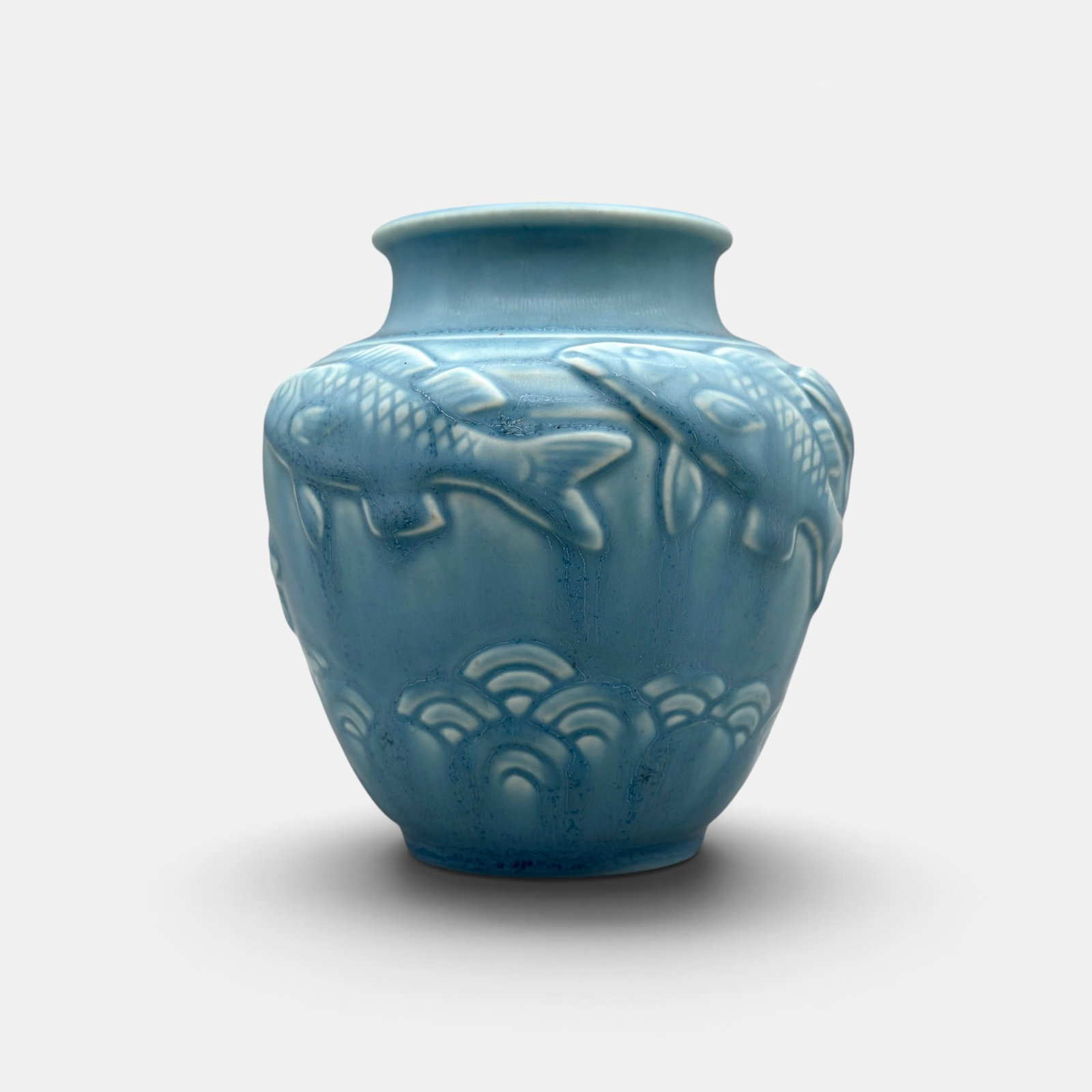 Rookwood blue mat production vase, fish, 1937: Rookwood blue productiion vase with embossed fish and a slightly crystalline mat glaze done in 1937 based on a Shirayamadani design. Impressed Rookwood logo, XXXVII, Shape number 6487. Height 4 1/2