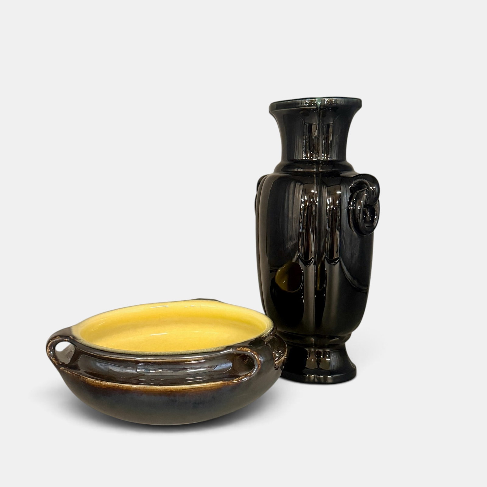 Two glossy Rookwood production items: Two glossy Rookwood production items. 1. Three handled bowl, dark brown exterior with yellow interior. Shape number 2163 B, 1923. Height 3 1/2 inches, diameter 9 inches. 2. Tall vase with cast looop