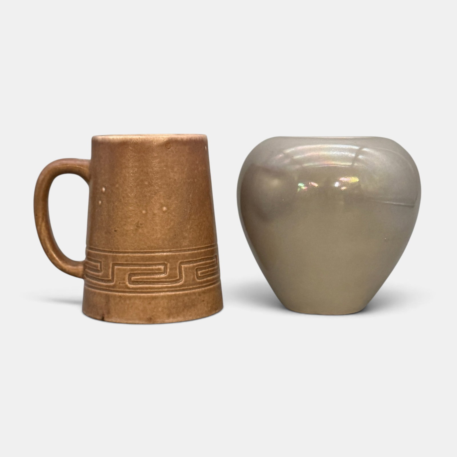 Two Rookwood Pottery Items: Two Rookwood items. 1. Albert Munson incised Z-line mat glaze mug from 1901. Impressed Rookwood logo, I, Shape number 345 CZ and AM monogram. Height 4 5/8 inches. 2. Nacreous Glaze vase in gray. Impre