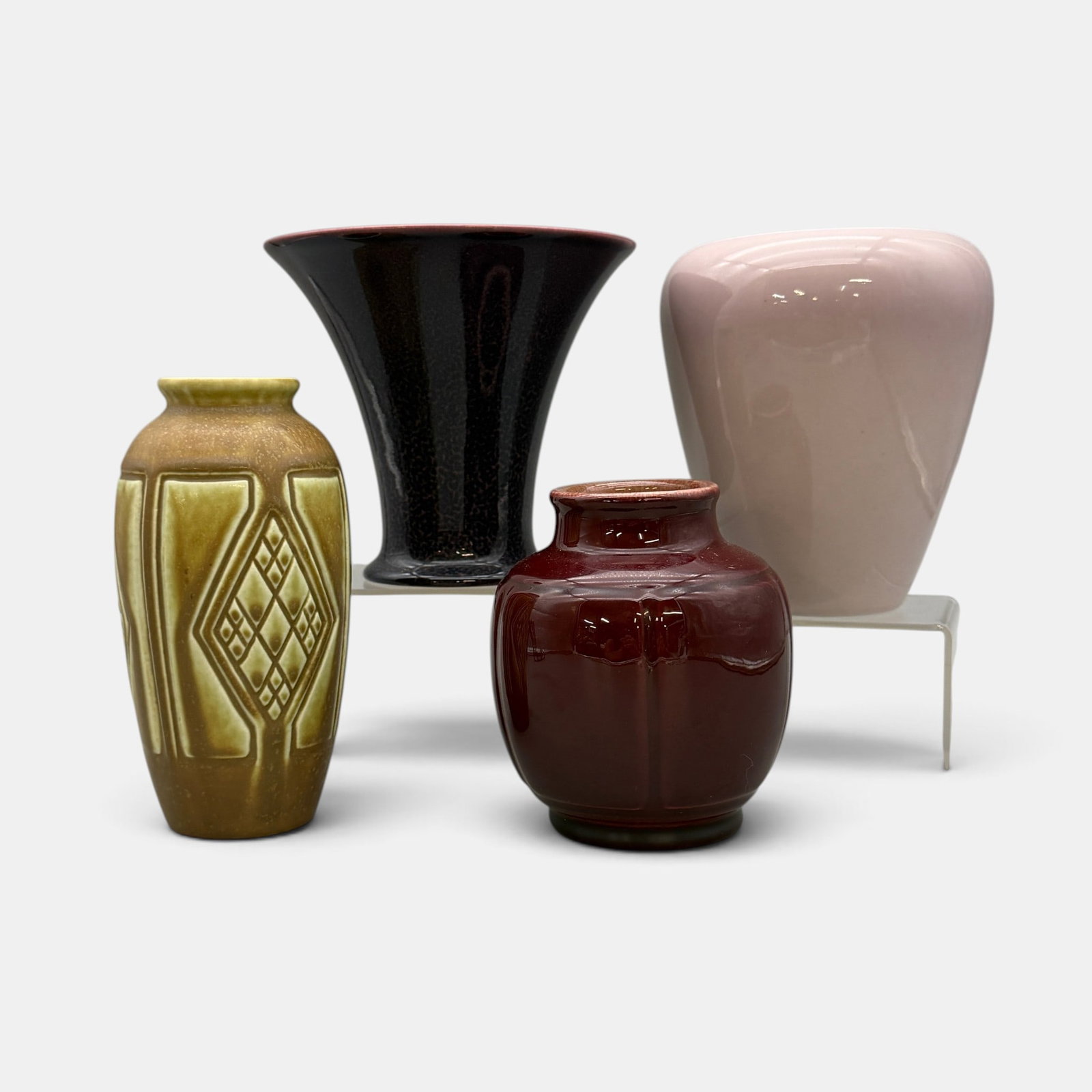 Four Rookwood production vases: Four Rookwood production vases. 1. Porcelain Purple and maroon, 1919, Shape 2236. 2. Porcelain Pink with blue interior, 1919, Shape 2005, Xed. 3. Mat, 1925, Shape 2415. 4. Maroon high glaze, 1948, Sha