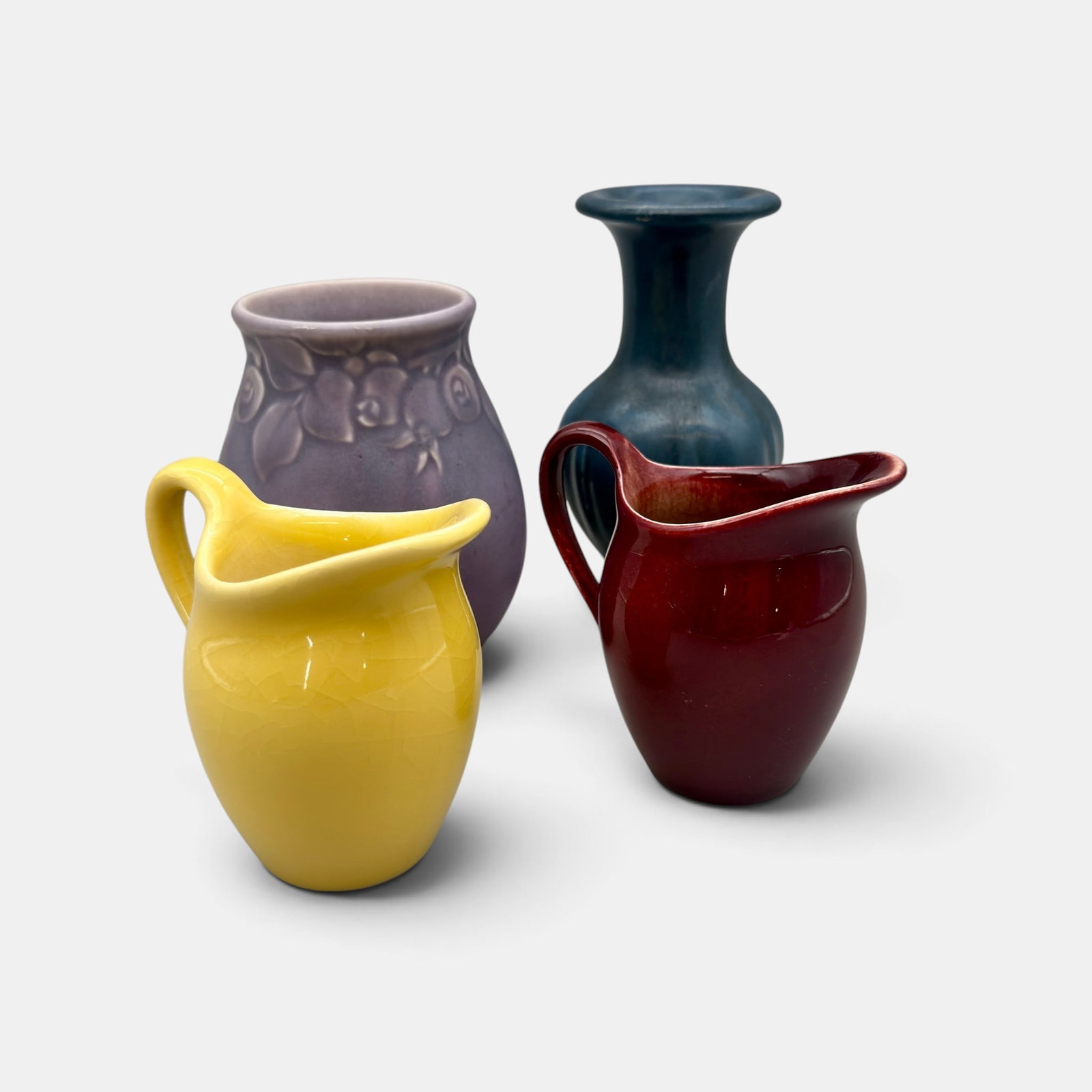 Four Rookwood production items: Four Rookwood production items including two small picthers, 1946 and 1950 and two vases, Shape 2122 and 2972 both from 1931. Impressed Rookwood logos. Tallest 5 3/8 inches.