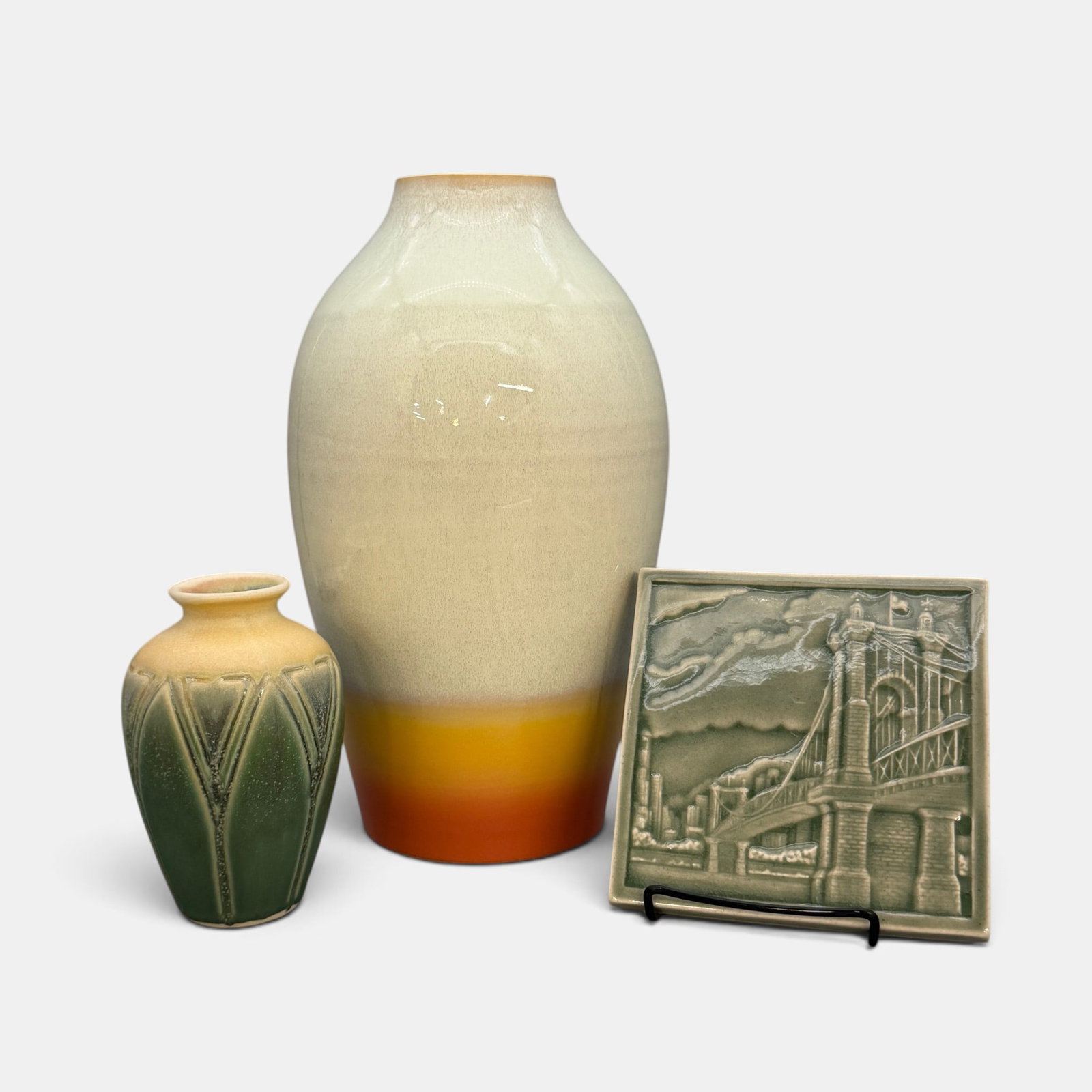 Three Contemporary Rookwood items: Three Contemporary Rookwood pieces including a glaze effect vase by Morgan Willenbrink done in 2019 which is 12 inches tall. Also included is an undated 5 3/4 inch tile featuring the Roebling bridge