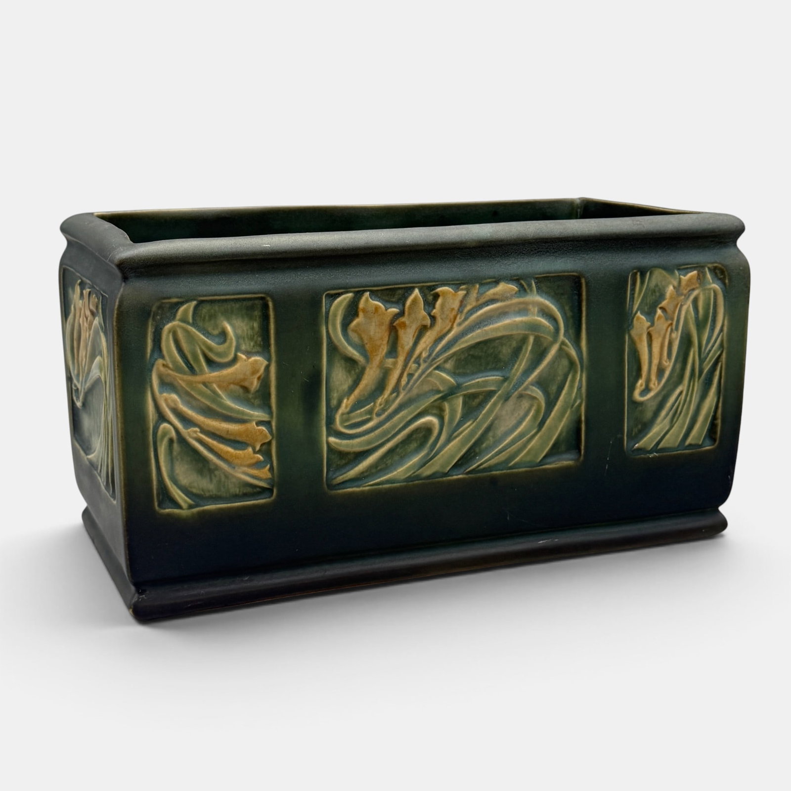 Roseville Rosecraft Panel planter: Uncommon Roseville Rosecraft Panel planter in green. Marked only with a Roseville RV inkstamp logo. Height 6 1/8 inches, length 11 1/4 inches, width 5 1/2 inches.