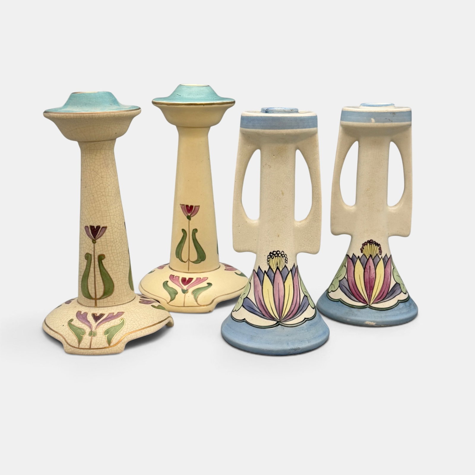 Two pairs of matching Roseville Ceramic candlesticks.: Two sets of Roseville Ceramic Design candlesticks. One set with twin handles. None are marked.