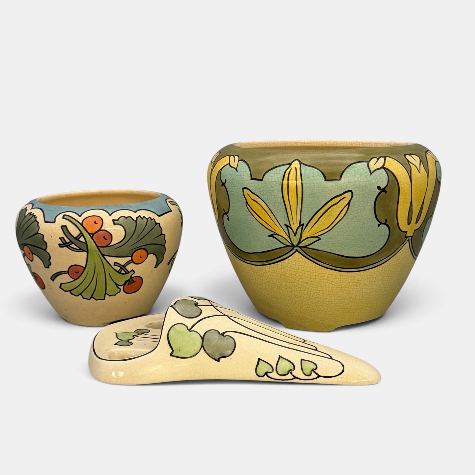 Three Roseville Ceramic Design Pieces: Three Roseville Ceramic Design pieces including two jardinieres and a wall pocket, each with colorful floral designs. None are marked. Height of the jards, 6 7/8 inches and 4 7/8 inches. Height of
