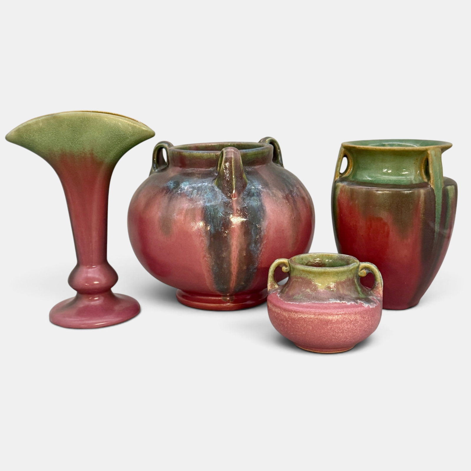 Four Fulper vases of various size: Four Fulper vases. 1. Blue over rose three handled vase, horizontal FULPER logo, height 6 3/4 inches. 2. Bullet vase, green over rose, veertical ink stamp logo, height 6 5/8 inches. 3. Small twin