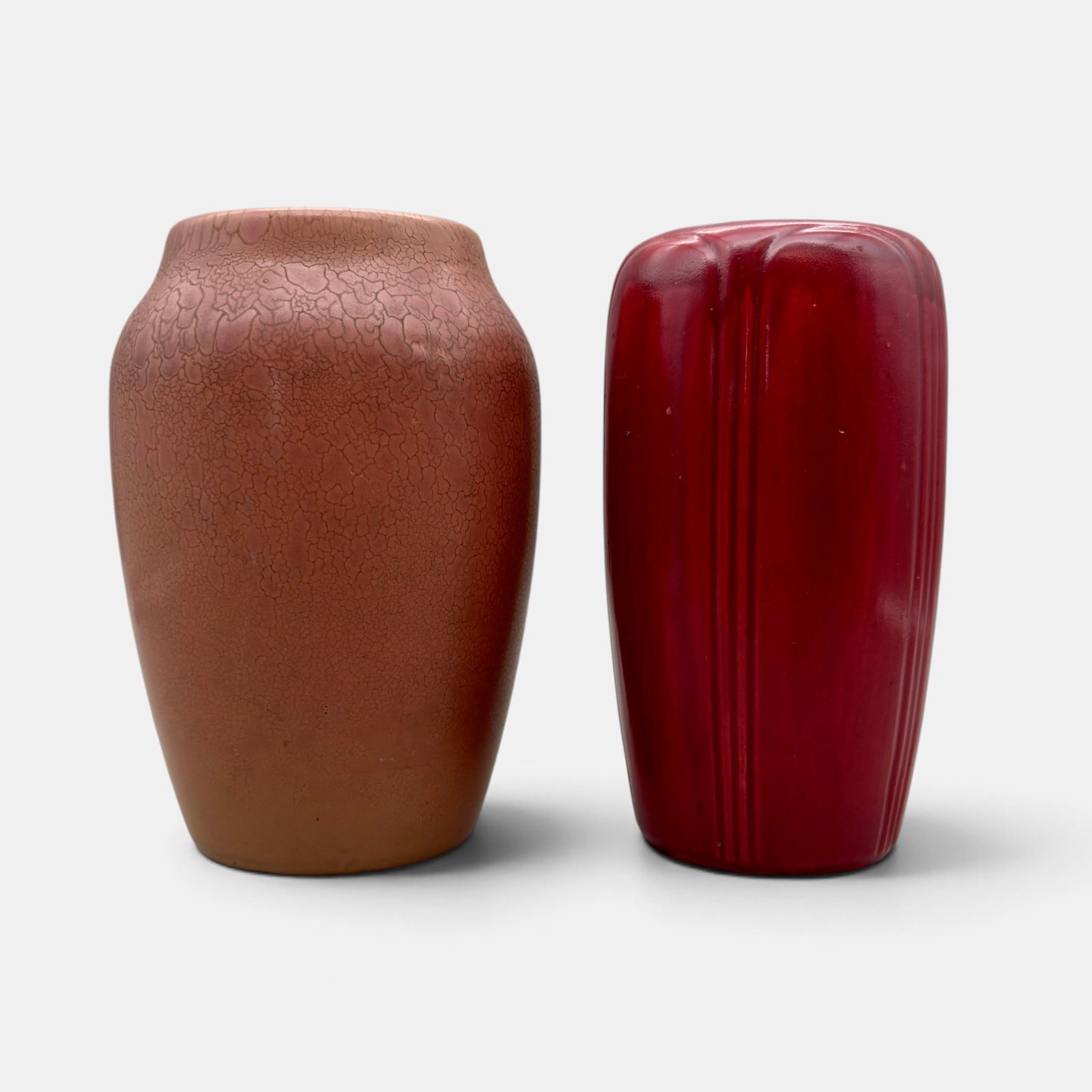 Two red Hampshire vases: Two red Hampshire vases. 1. Mottled mat finish., shape number 1814, 7 7/8 inches tall. 2. Semi-gloss finish, shape 131, 7 3/4 inches tall. Both impressed Hampshire Pottery, MO
