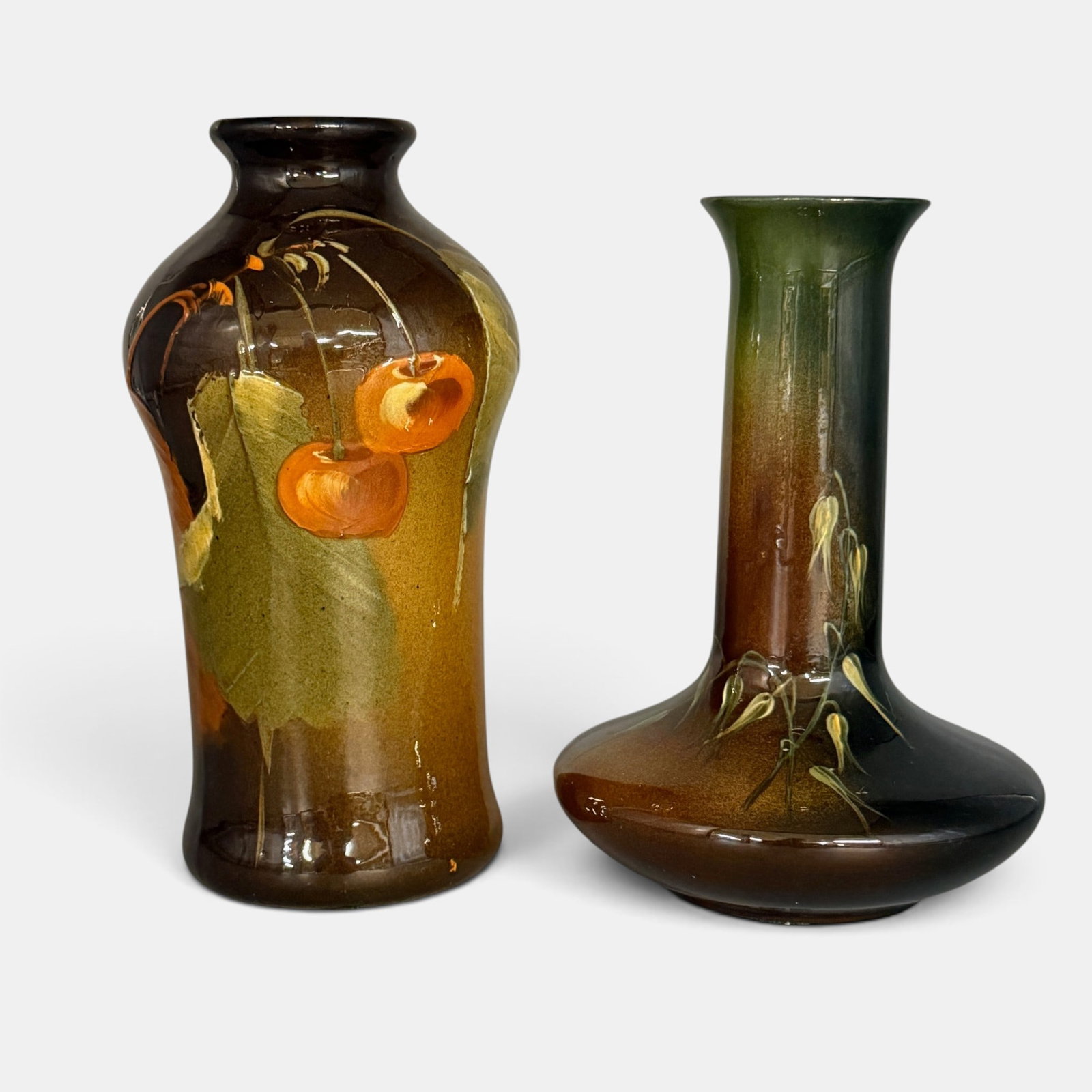 Two Owens vases, Utopian and Lightweight: Two Owens vases. 1. Utopian vase with cherry decoration. Impressed Owens Utopian 128 along with Ragoarts auction label. Heifht 7 1/2 inches. 2. Lightweight vase with delicate floral decoration done