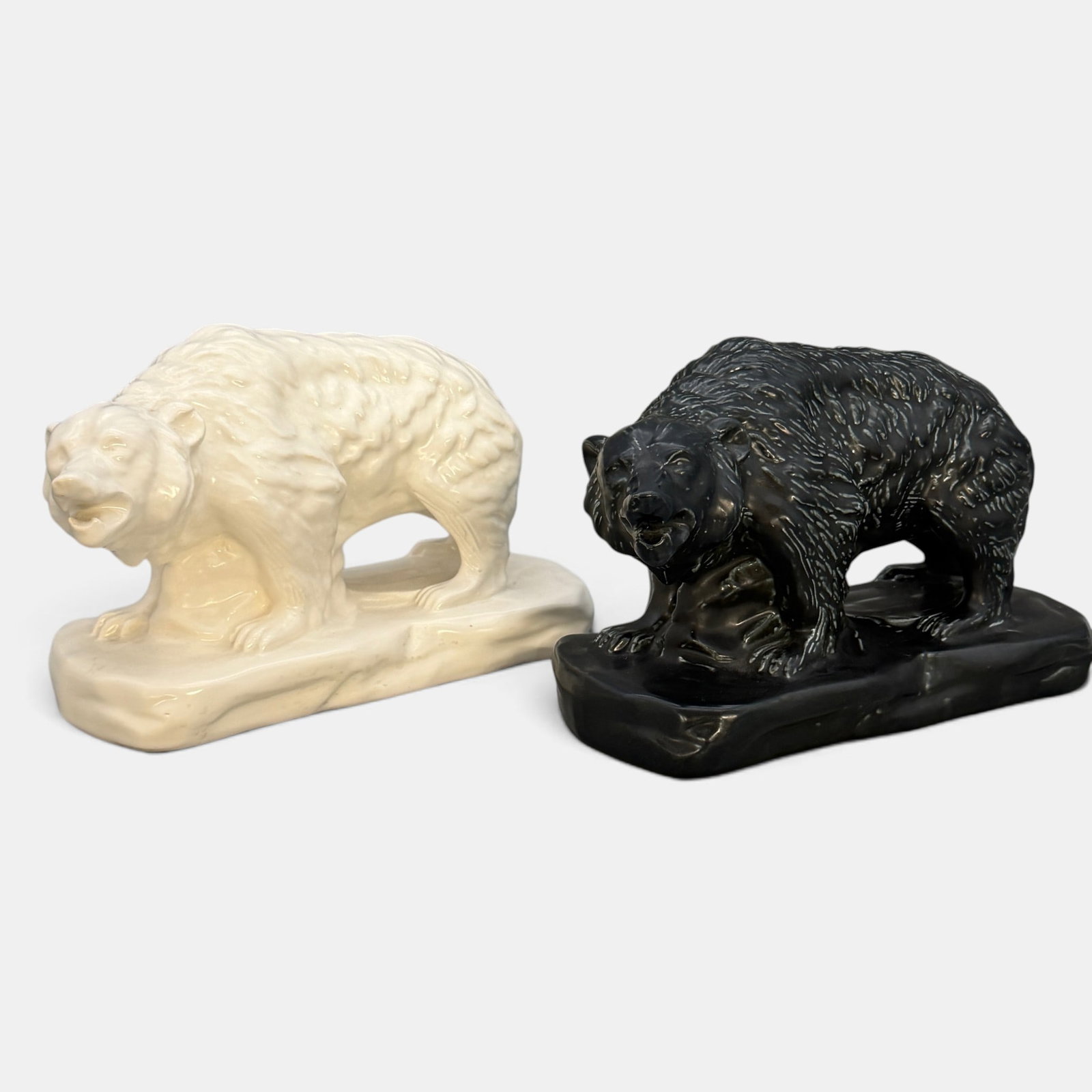 Two Mosaic Tile Company Bears: Two Mosaic Tile Company bears, one white and one black over green. Impressed Mosaic log on underside of both. Height of each is 6 inches, length of both is 9 3/4 inches.