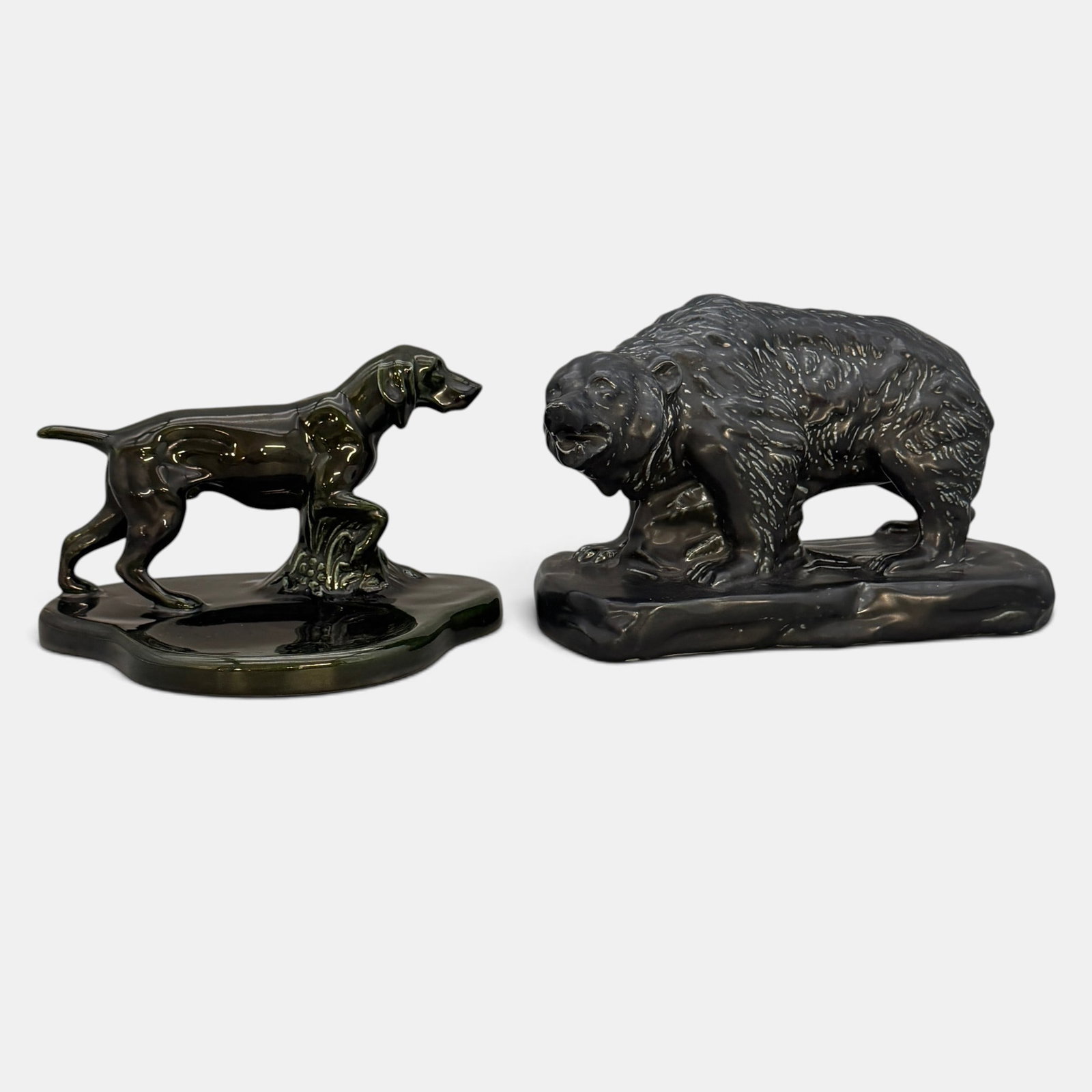 Mosaic Tile Bear and Dog pen tray: Mosaic Tile Company Bear paoerweight in black over green glaze and Pointer pen tray in a rich maroon glaze. The Bear has impressed Mosaic logos while the maroon pointer is unmarked. Height of tallest