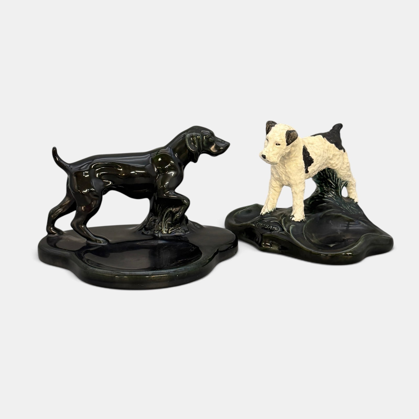 Two Mosaic Tile Company dog trays: Two Mosaic Tile Company dog trays. 1. Pointer tray in gloss black. 2. Black and white Scottie dog tray. Both with impressed Mosaic Tile Company Zanesville & New York logos. Height of the pointer is 5