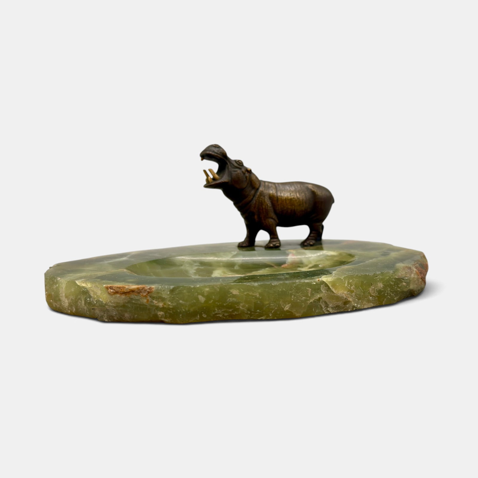 Bronze Hippo ashtray with onyx base: Nicely detailed bronze Hippo ashtray with onyx base. One of the screws mounting the hippo is impressed Germany. Height 2 5/8 inches, width 7 1/2 inches.