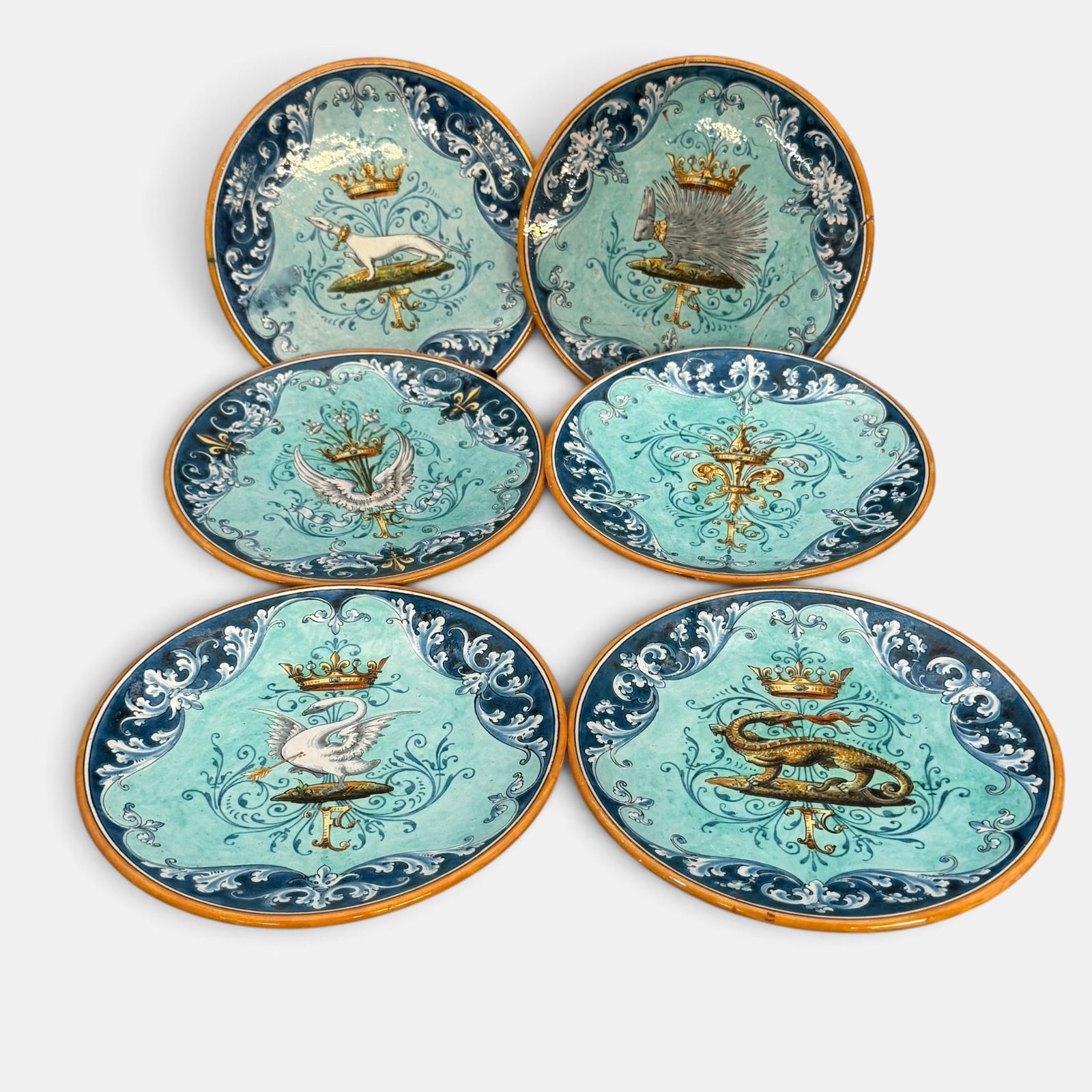Group of French Faience Heraldic Plates: Early 20th century, Blois, France, a group of blue ground faience dishes, one with restored cracks, each marked to underside. Diameter 7".