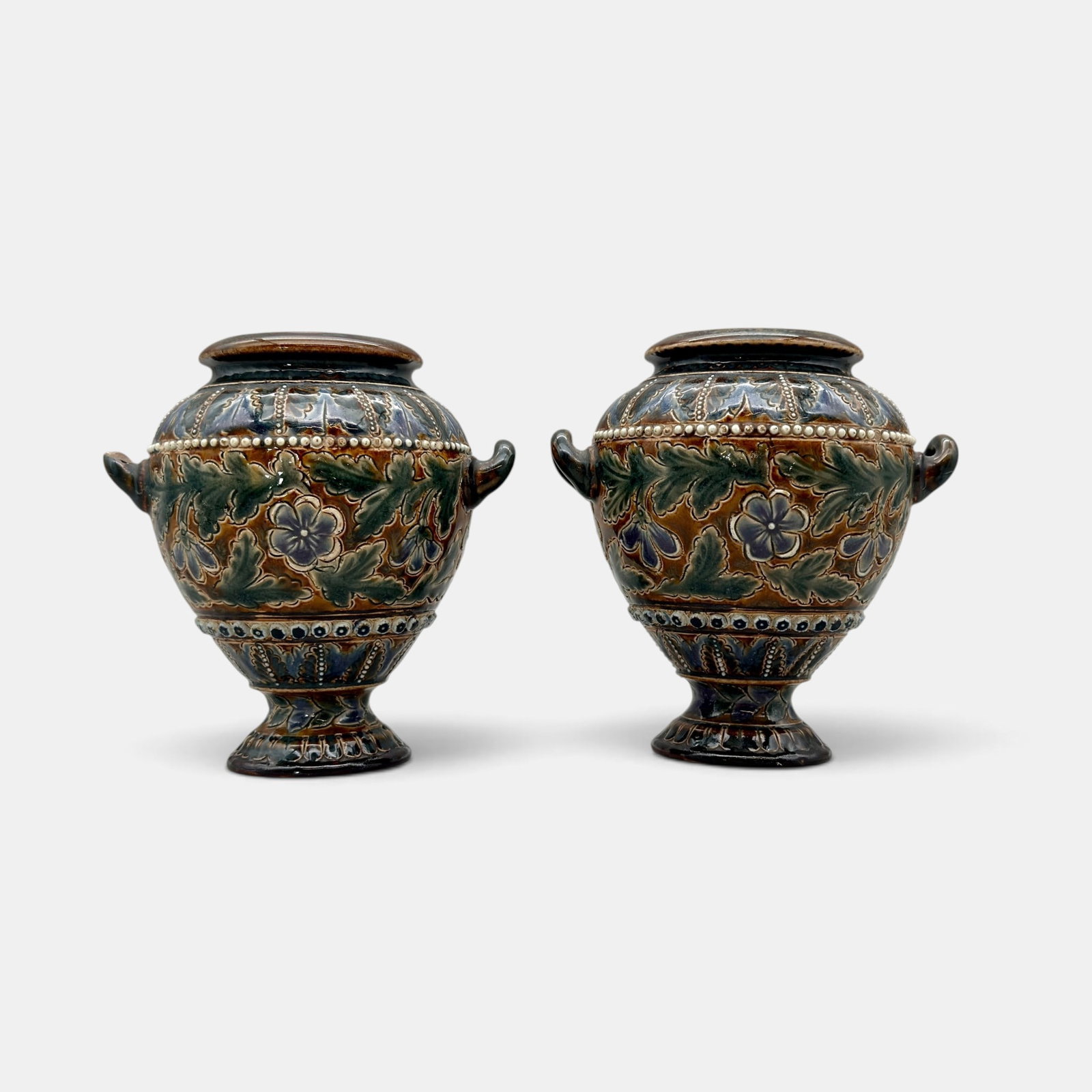 Pair of Doulton Lambeth stoneware vases, 1879.: Pair of Doulton Lambeth stoneware vases with floral design dated 1879. Impressed Doulton logo, incised artisan marks. Height of each 4 3/4 inches.