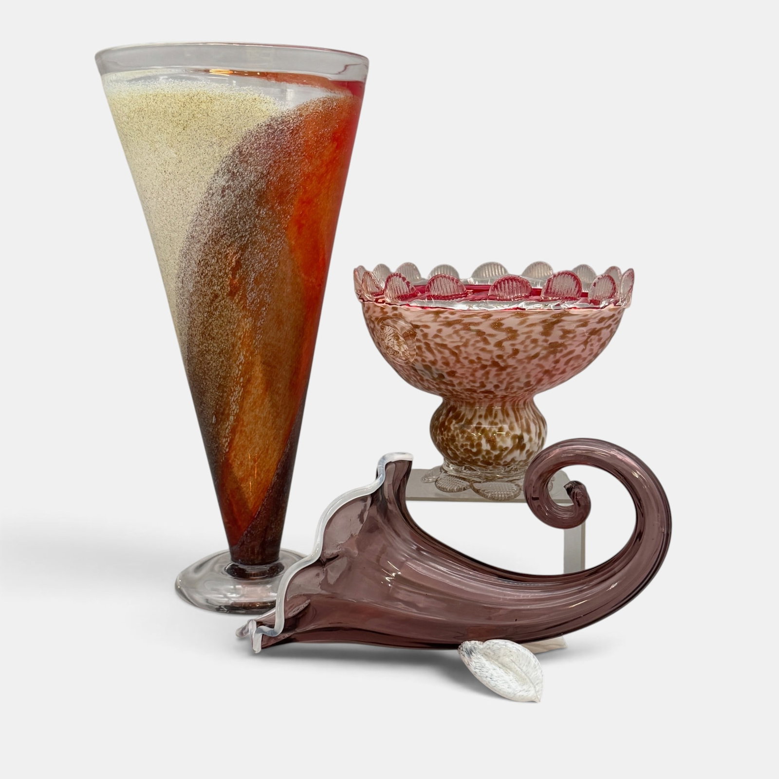 Kosta Boda and Venetian Glass Examples: Including a Kosta Boda trumpet vase, a Venetian globular dish, and a Elli Toio cornucopia. Tallest ht. 13.5".