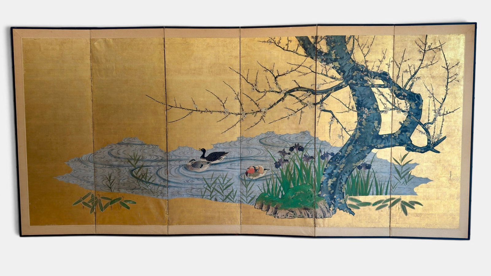 Kano School Screen with Attribution to Kano Naonobu: Edo Period, a screen with gold wash to background in four panels, with signing to the mounting, as well as signed l.r. to the 4th panel. Each panel measures 67" x 24".