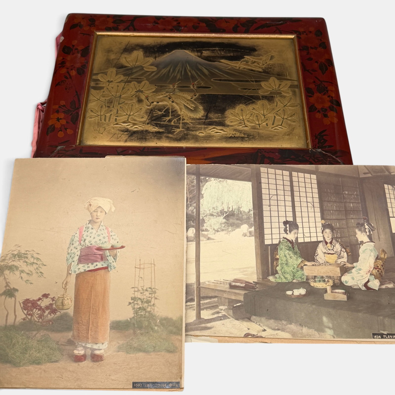Japanese TInted Photograph Album in Fine Lacquer Case: Ca. 1900, a Japanese photograph album, with numerous portrait, scenic and cultural views. Housed in cover boards with floral and gilt lacquer decoration, well preserved.12" x 15.5".