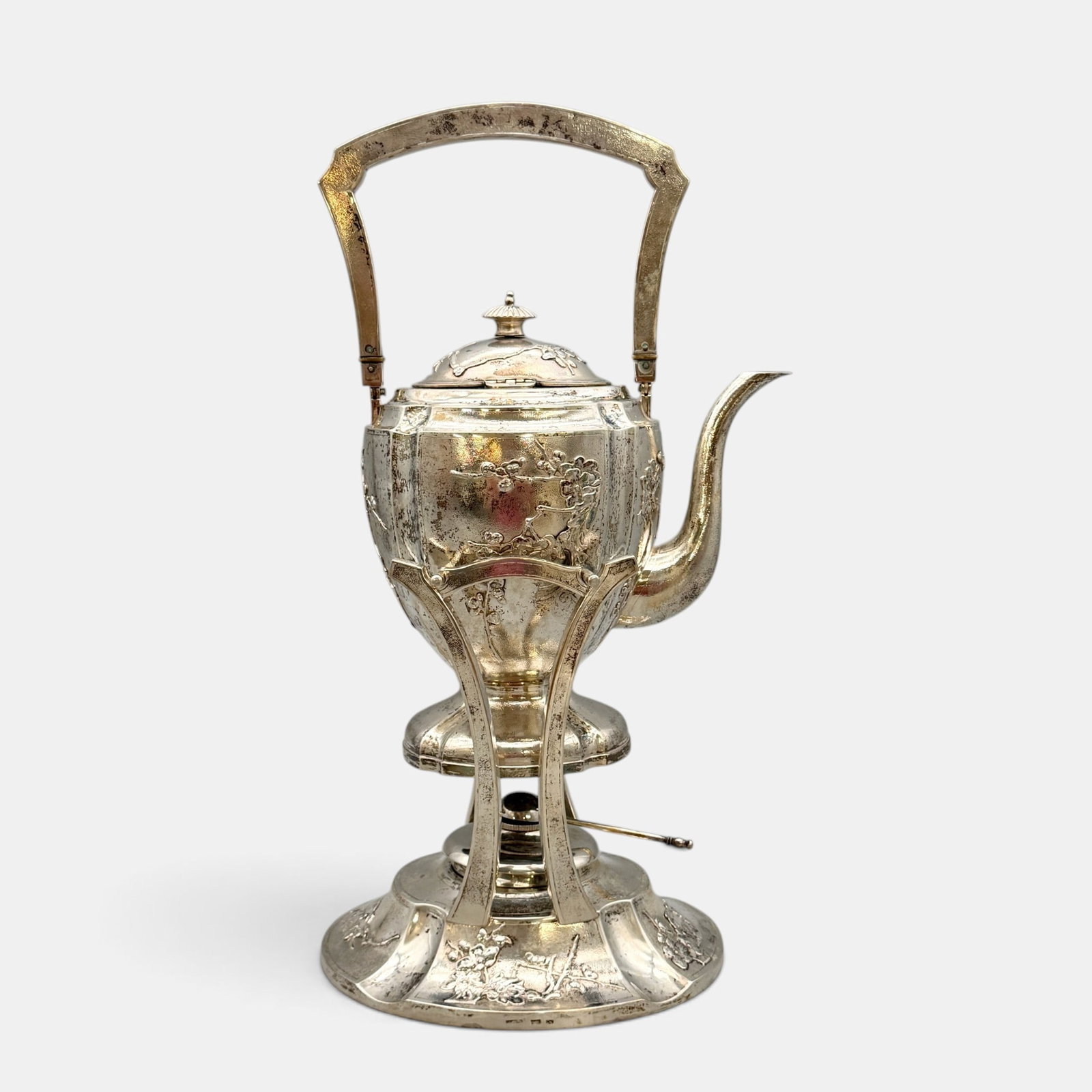 Japanese Sterling Teapot and Stand: Early 20th century. A sterling teapot with floral repousee to the pot and stand, each section hallmarked "C.J." and for sterling. Ht. 16". Total weight 54.47 ozt.