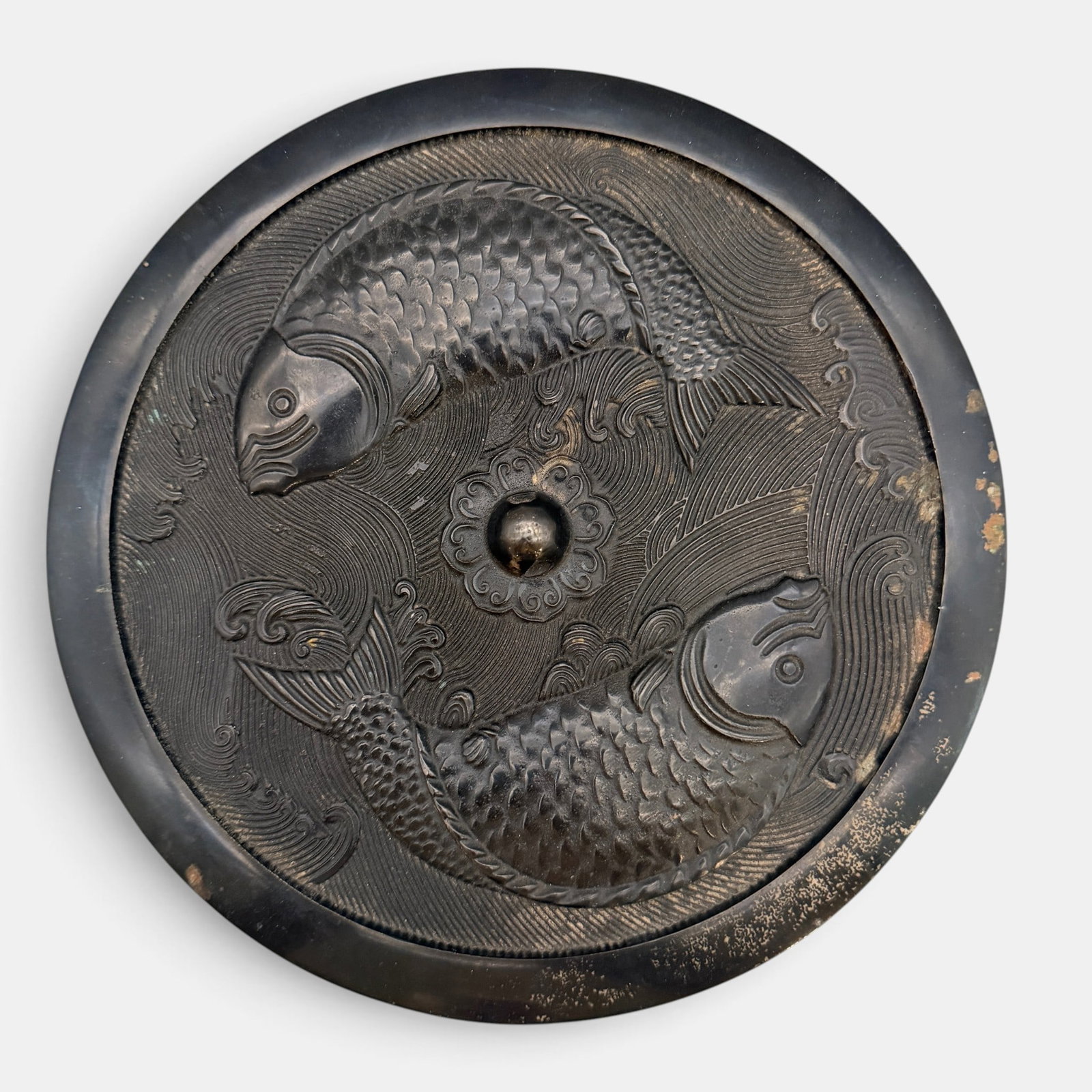 Chinese Bronze Mirror: Featuring twin fish cast in relief in circling manner. 8.5" diameter