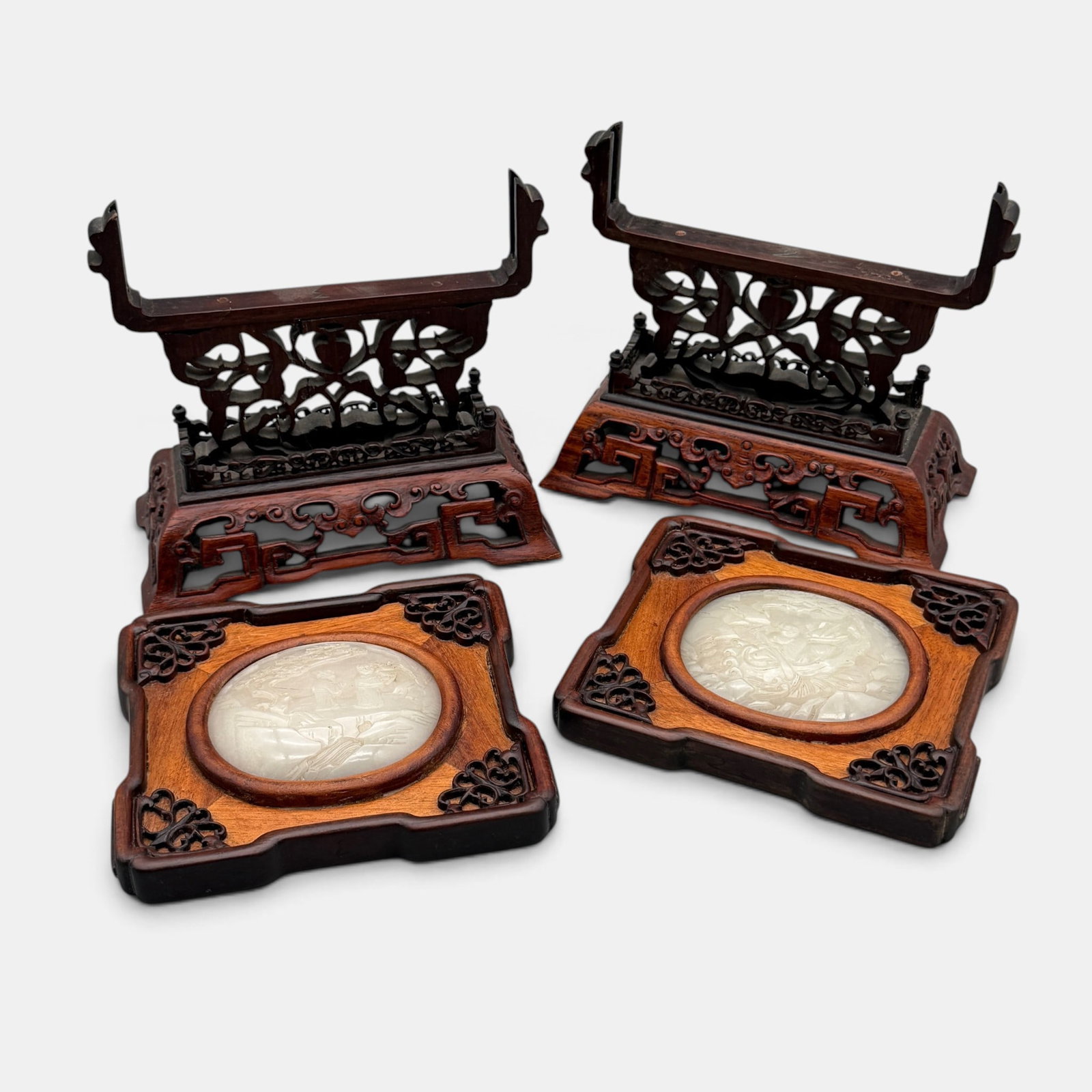 Pair of Nephrite Jade Carved Plaques on Stands: Each Chinese, late 19th century. Nephrite plaques with scholars in relief on period rosewood stands.