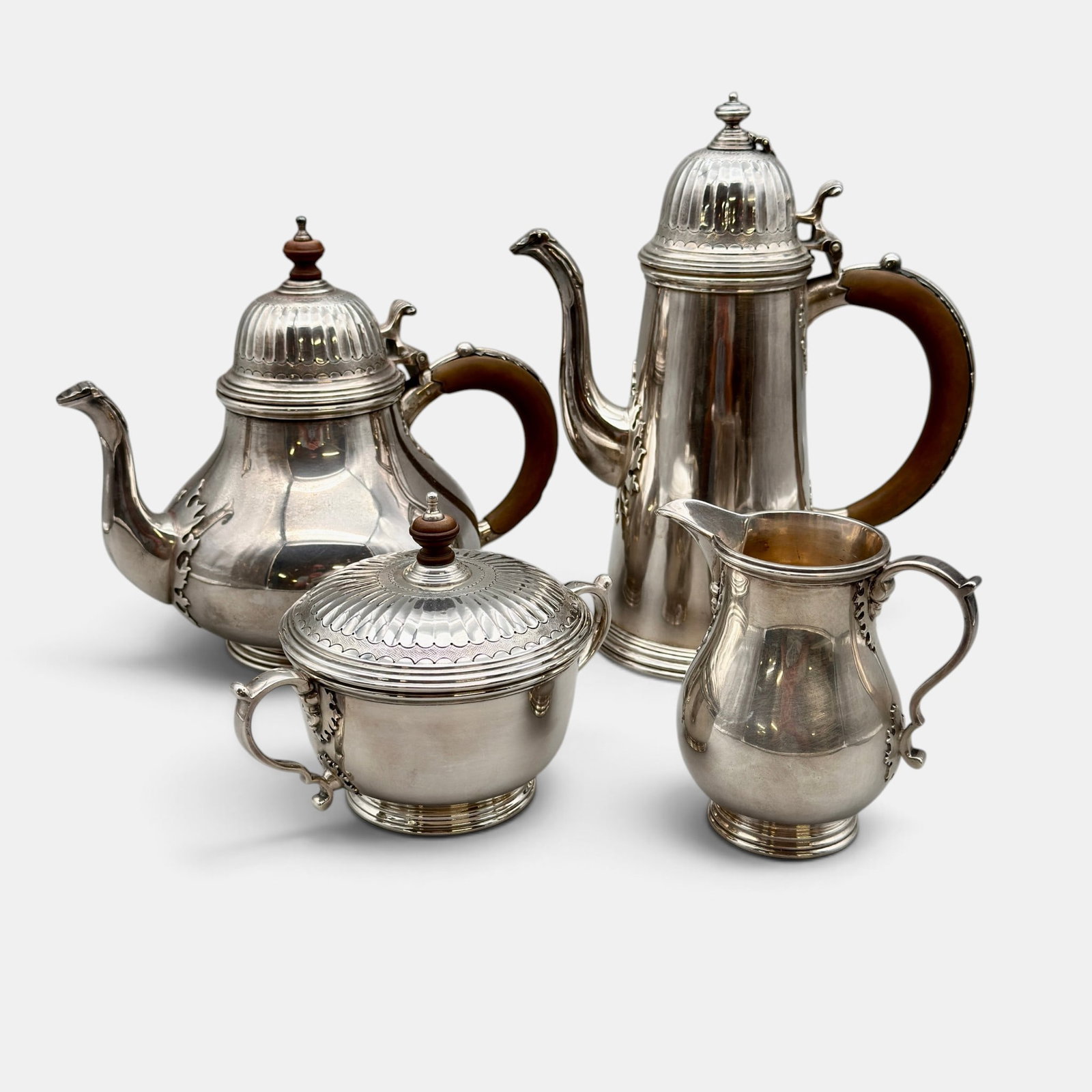 Four Piece Sterling Silver English Tea and Coffee Service: A reproduction of pieces made by the famous Queen Anne silversmith, William Lukin. Total troy ounce weight: 86.35 troy ounces