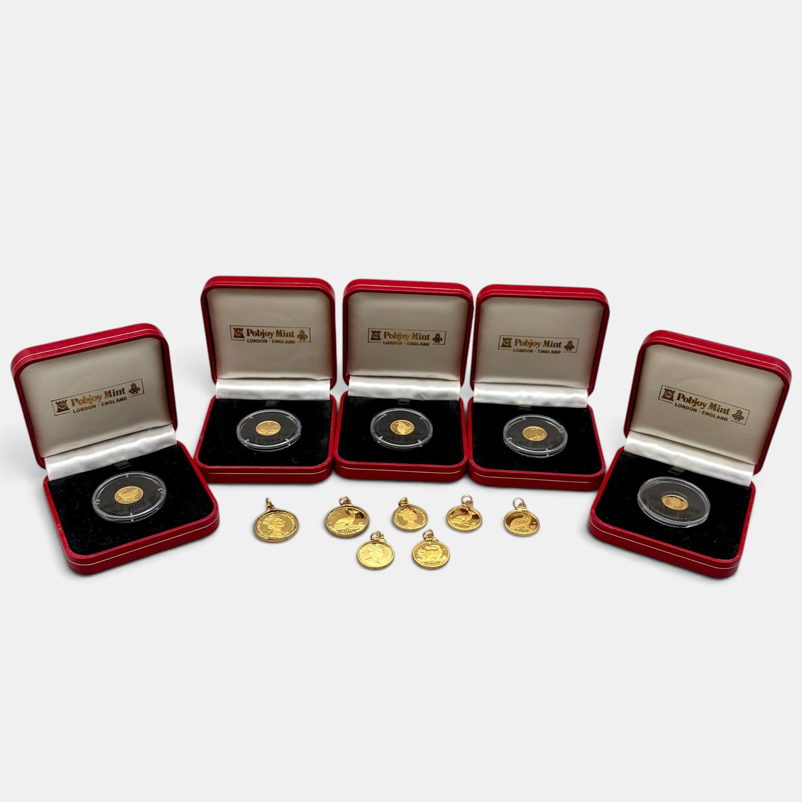 Group of Fourteen Poljoy Mint Gold Cat Crowns: Nine Poljoy Mint gold cat crowns, including two 1/5 oz. gold crowns with bezels, five 1/10 oz. coins with bezels and five 1/25 oz. gold cat crowns