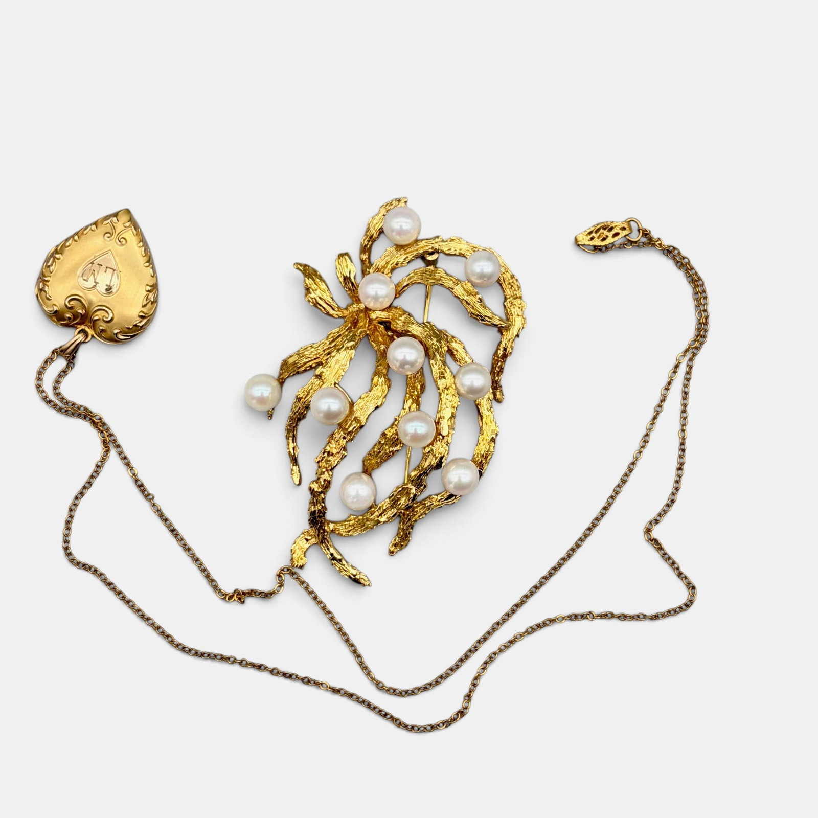 Pair of Gold Items, One 10k and one 14k: A 14k gold brooch with pearls, marked 585 and 14k to the reverse, and a 10k heart locket with chain