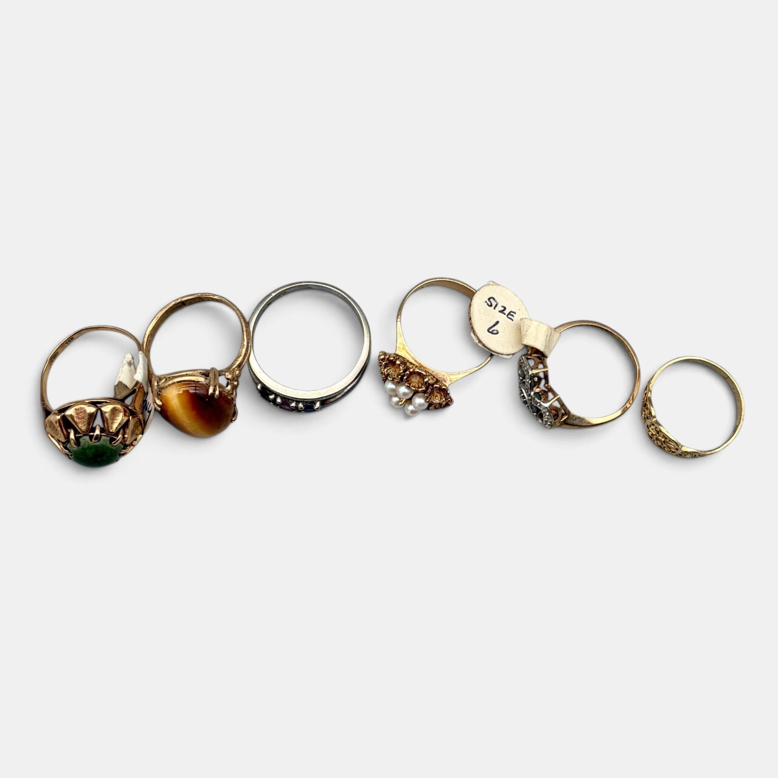 6 Rings in 10k Gold Settings: Different stones, including 6 rings, each in 10k settings. Total weight .58 ozt.