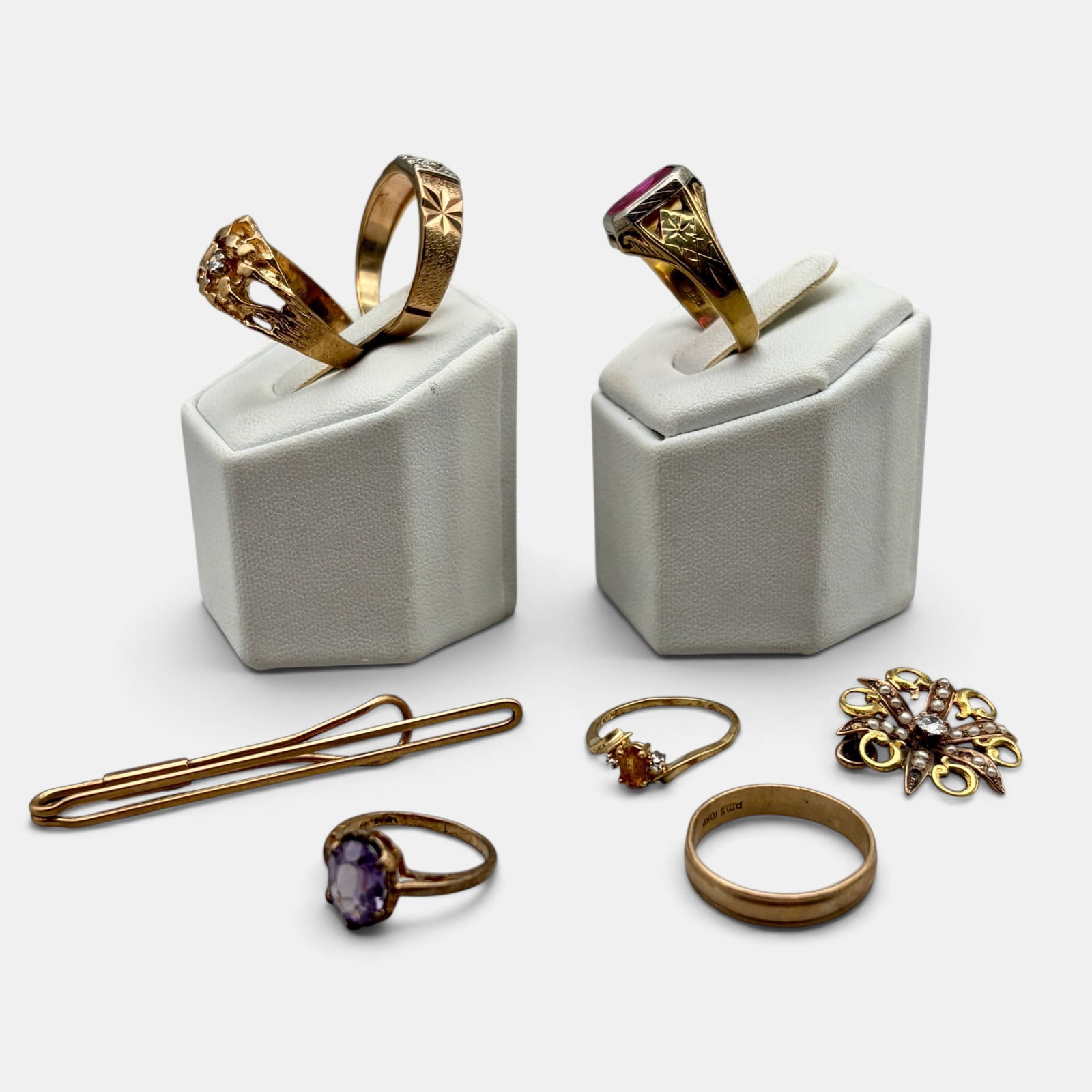 Collection of 10K Gold Rings and Other: Total weight .84 ozt. Including 7 rings with varying stones, each hallmarked for 10k, and a money clip.