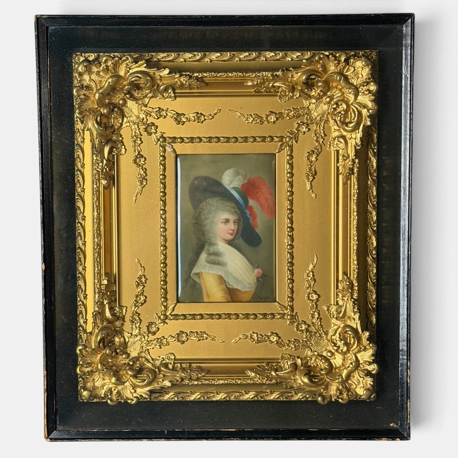 Charming Hutschenreuther plaque signed Wagner.: Charming Hutschenreuther plaque featuring an elegant young women wearing a large black hat with red plume feather and a rose in her bodice. Signed Wagner lower right. Marked Devonshire 107 Germany and