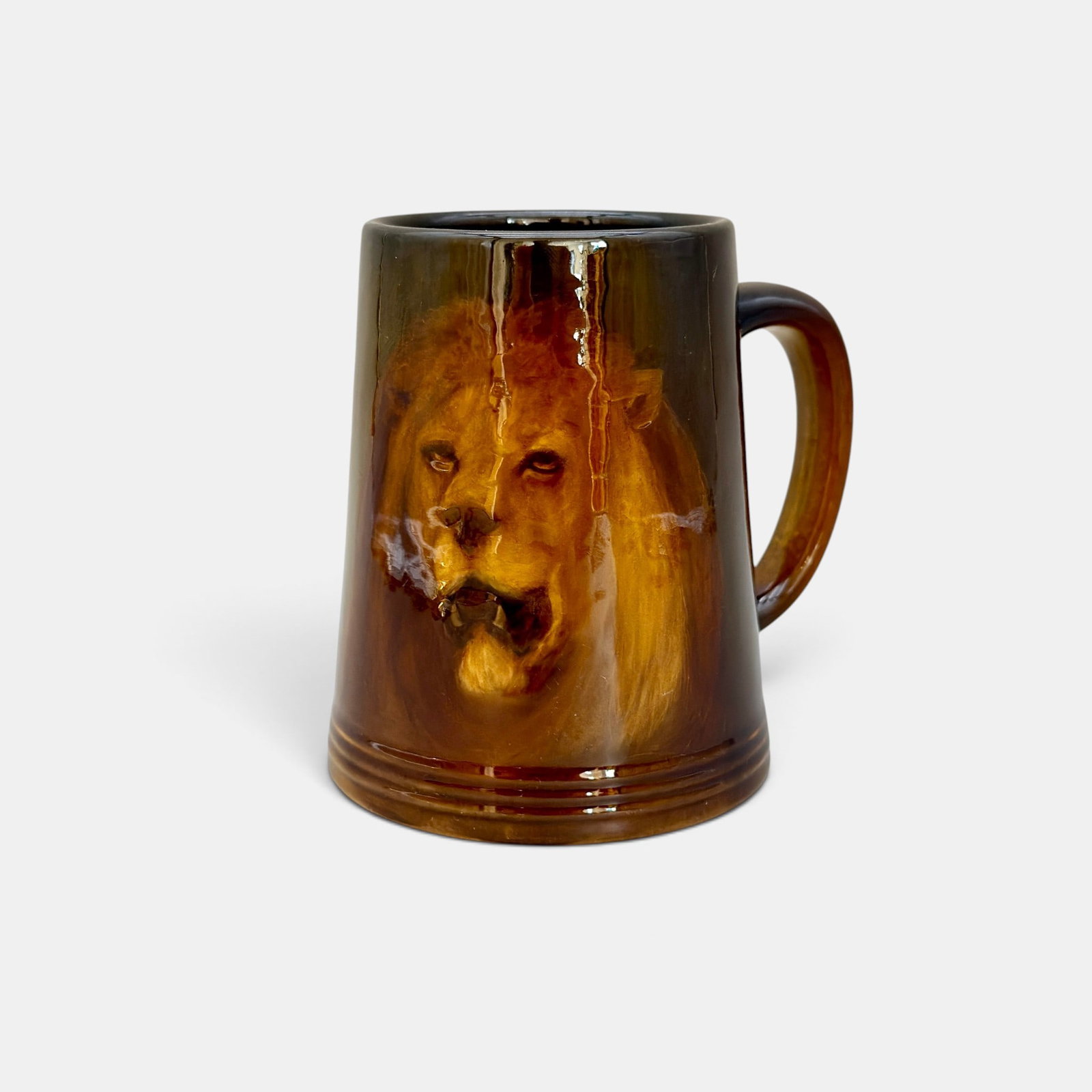 Rookwood Standard glaze mug, lion portrait, Hurley, 1898.: Rookwood Standard glaze mug with portrait of a growling lion done in 1898. Impressed Roowood logo with 12 flames. Shape number 587 C. Incised ETH initials. Humler & Nolan paper label for lot 1050.