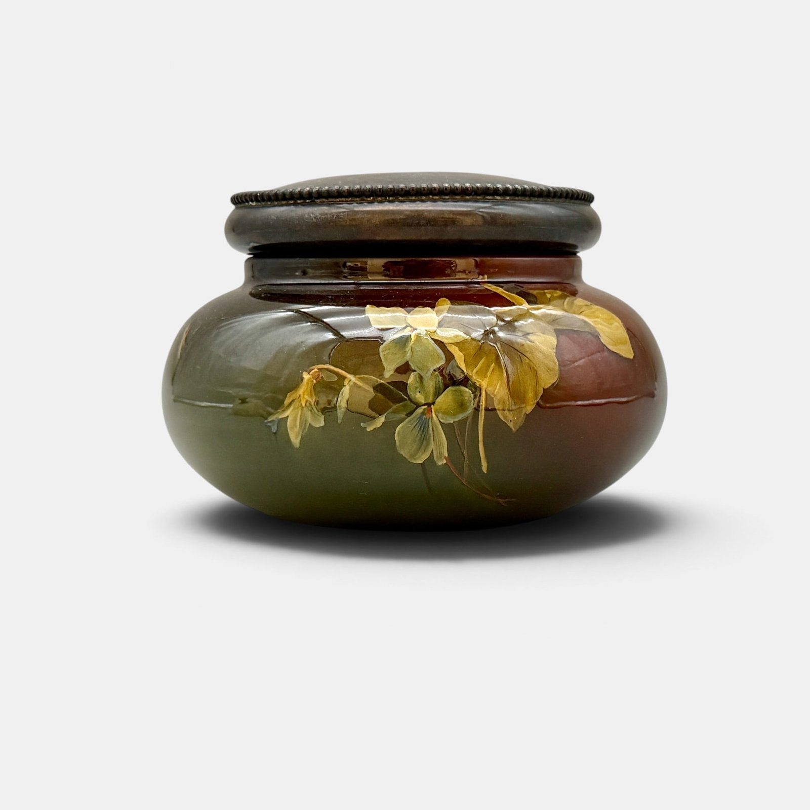 Rookwood powder box with Sterling lid, 1894.: Rookwood Standard glaze powder box with violet cecoration done by Bruce Horsfall in 1894 and a monogrammed Sterling silver lid and matching monogrammed knob for the powder puff. Impressed Rookwood log