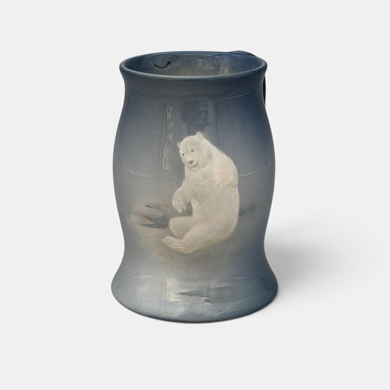 Rare Rookwood Aerial Blue mug with Polar Bear, Shirayamadani, 1896.: Rare Rookwood Aerial Blue mug with a smiling Polar bear, the work of Kataro Shirayamadani in 1896. Impressed Rookwood logo with 10 flames, Shape number 761. Incised artist's cypher. Height 5 inches.