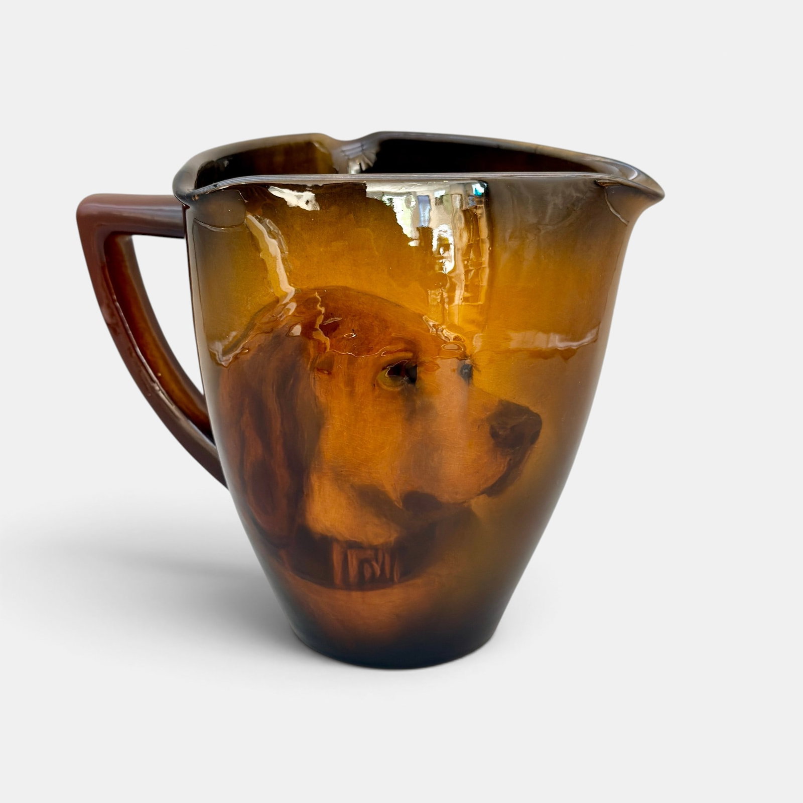 Standard glaze Rookwood pitcher, doggie, Hurley, 1899.: Large tri-cornered pitcher with an E.T. Hurley portrait of a soleful looking dog with collar, done in 1899. Impressed Rookwood logo with flames, shape number 269 B, incised E.T.H., wheel ground X and 