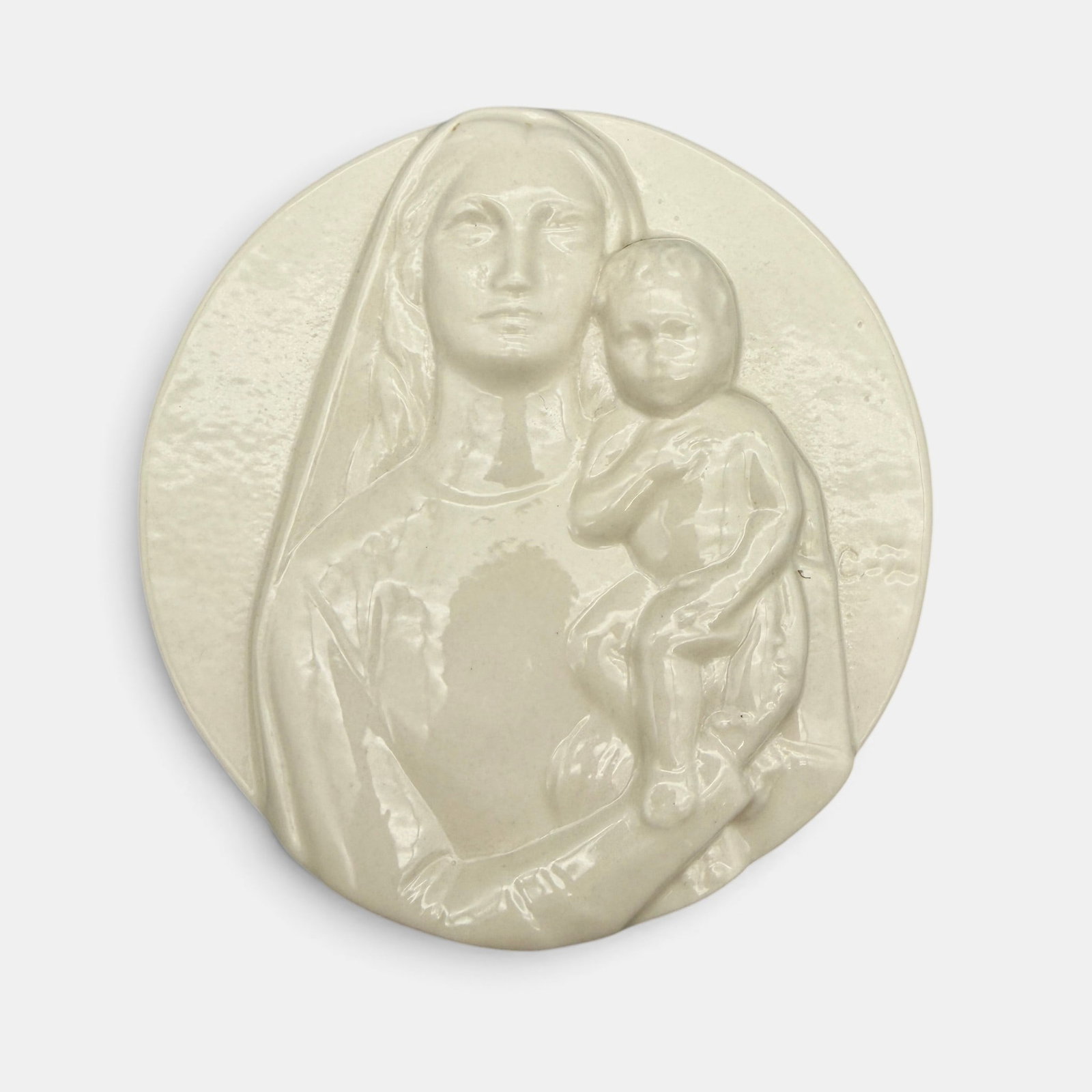 Our Lady of Cincinnati medallion, 1958.: Rookwood "Our Lady of Cincinnati" medallion, a Clotilda Zanetta design, done in white mat glaze in 1958. Impressed Rookwood logo, LVIII. No shape number but this is Shape 7155. Height 3/4 inches,