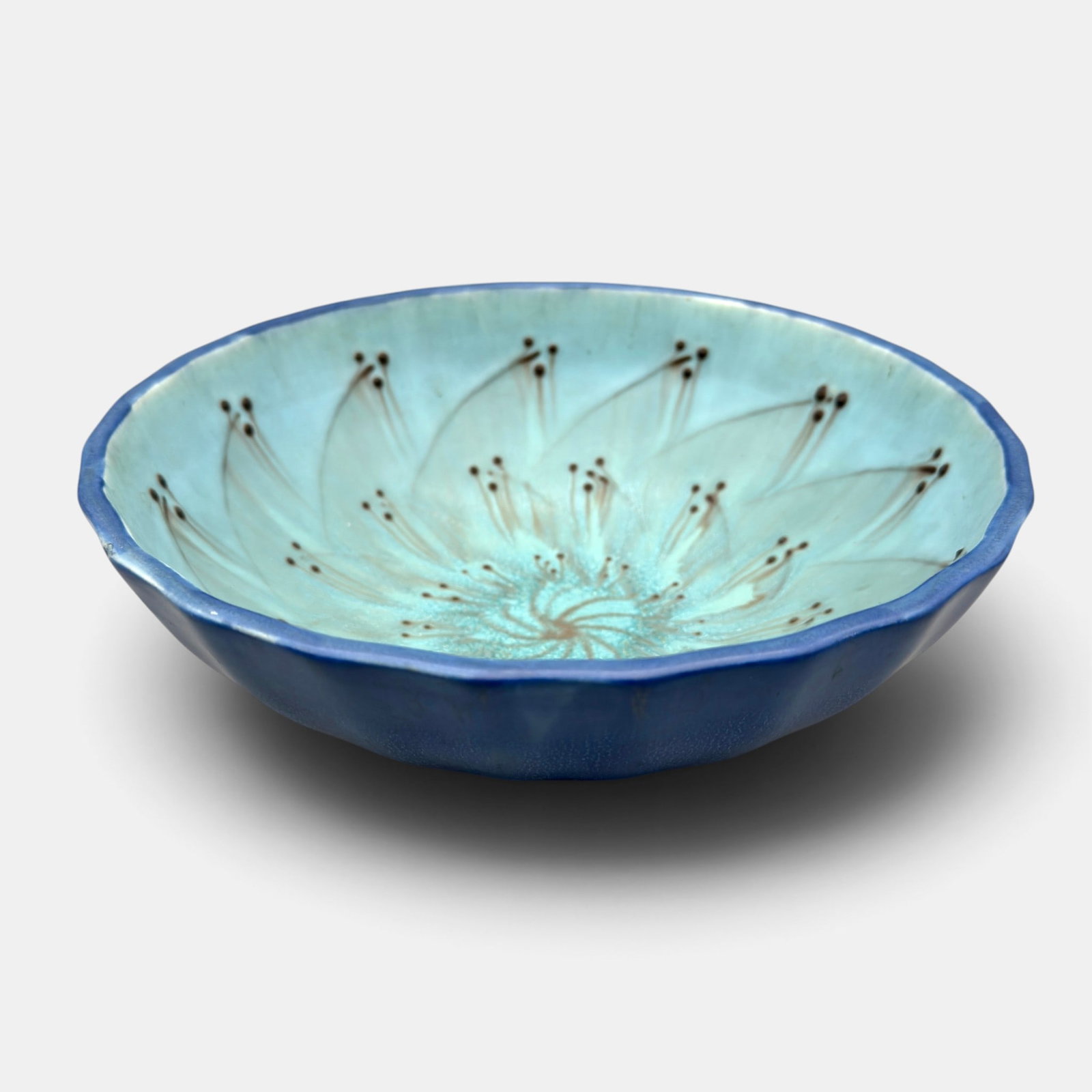 Rookwood bowl, pinwheel of flowers, Hentschel, 1926.: Rookwood mat glaze bowl with a pinwheel of flowers on the interior. Impressed Rookwood logo, XXVI, Shape number 2755. Incised WEH. Height 2 7/8 inches, diameter 8 1/2 inches.