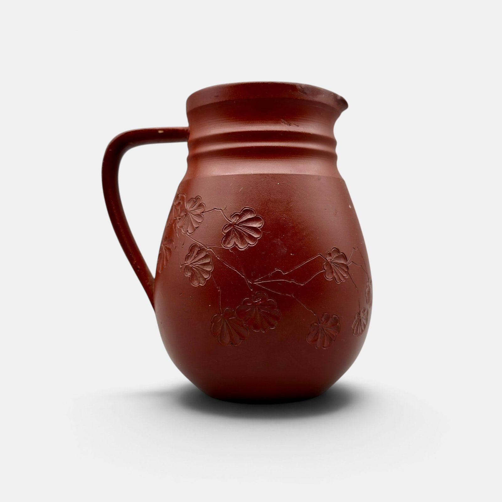 Rookwood Dull Finish pitcher, incised flowers, Anna Valentien, 1885.: Rookwood Dull Finish pitcher with incised flowers, the work of Anna (Bookprinter) Valentien in 1885. Impressed ROOKWOOD 1885, Shape number 54 C, R for red clay. Incised AMB 910. Height 5 1/4 inches.