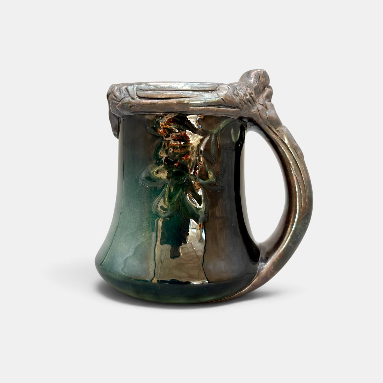 Rookwood Commercial Club mug, Rookwood silver, 1905: Rookwood Sea Green Commercial Club mug with Rookwood electroplated silver rim and handle and embossed clover decoration, hand colored by E.T. Hurley in 1905. Impressed Rookwood logo, V, "Commercial Cl