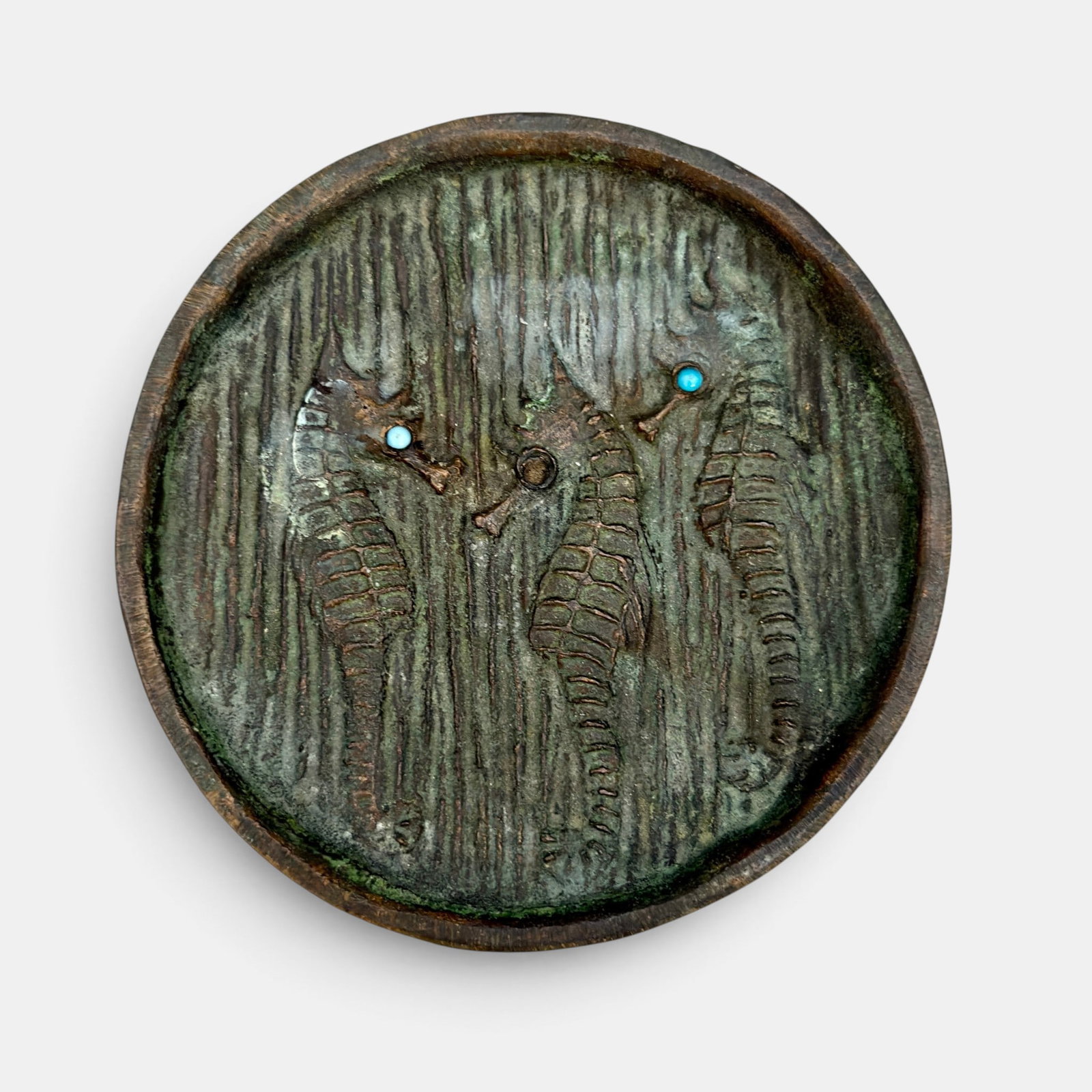Hurley Bronze tray with 3 seahorses: Hurley Bronze with three seahorses, two of which have blue eye. Marked E.T.Hurley and ETH on the reverse, with a copyright symbol above. Diameter 3 7/8 inches.