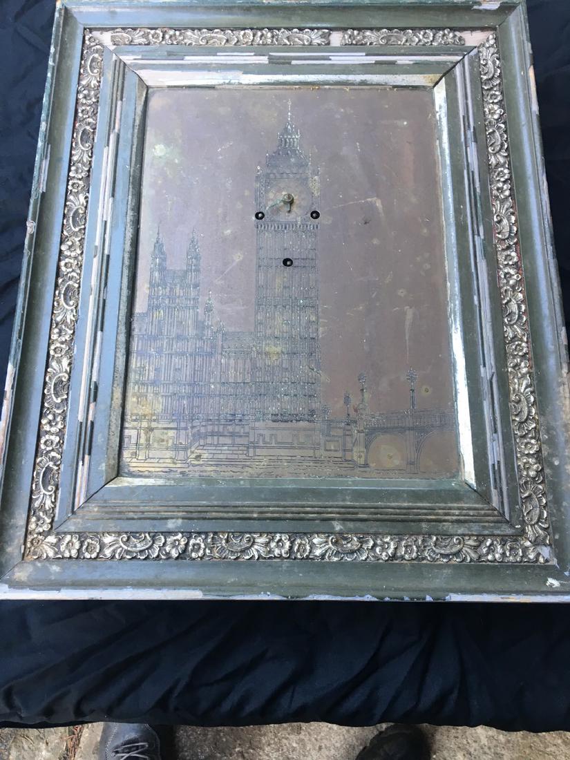 FINE BRITISH PICTURE FRAME CLOCK: By “Prudential Art Trading Co., Ltd.”, London with an engraved brass plate as dial and picture with image of the Parliament and Big Ben, in ornate silver gilt gesso frame with extensive printed la