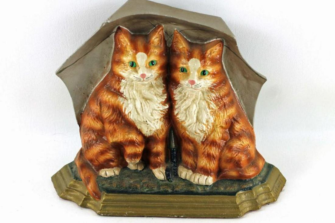 Cast Iron Door Stop with Cats Under an Umbrella: Cast iron door stop featuring 2 orange cats under an umbrella