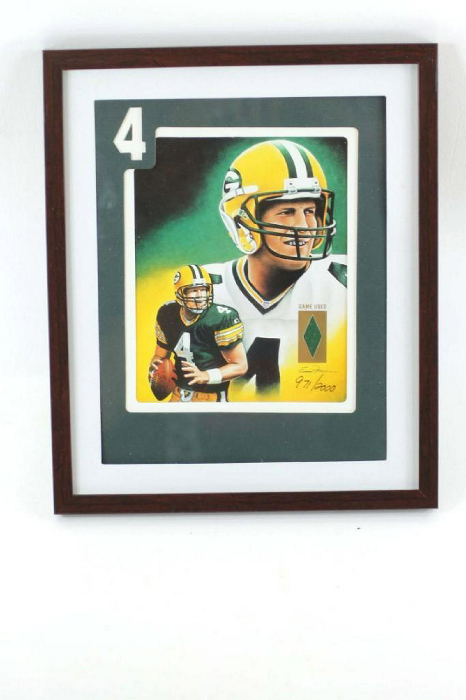Framed Print of Brett Favre with a Piece of Game Used: Framed Print of Brett Favre with a Piece of Game Used Shirt and Hologram COA
